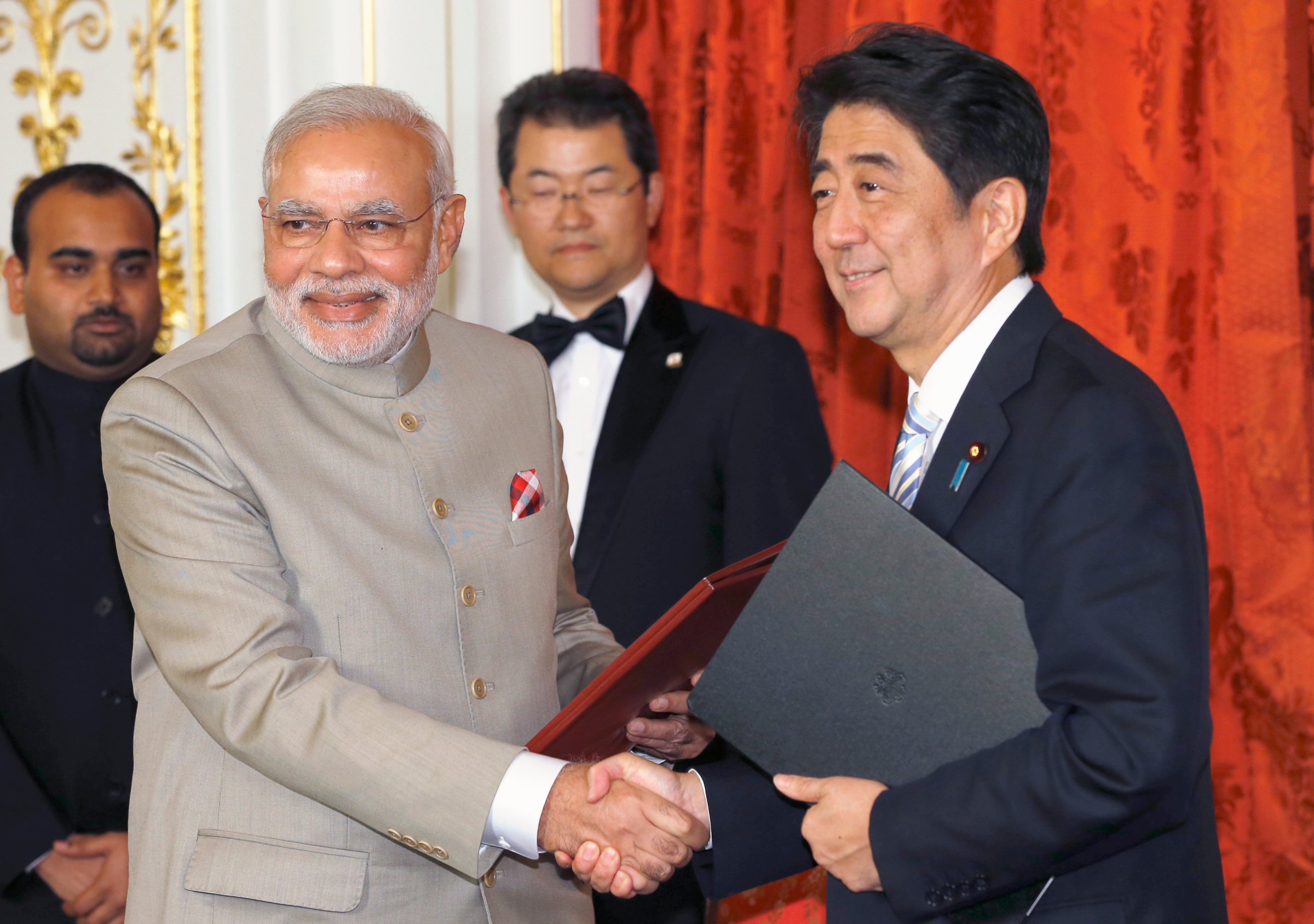 India's PM Modi shakes hands with Japan's PM Abe during a signing ceremony at the state guest house in Tokyo