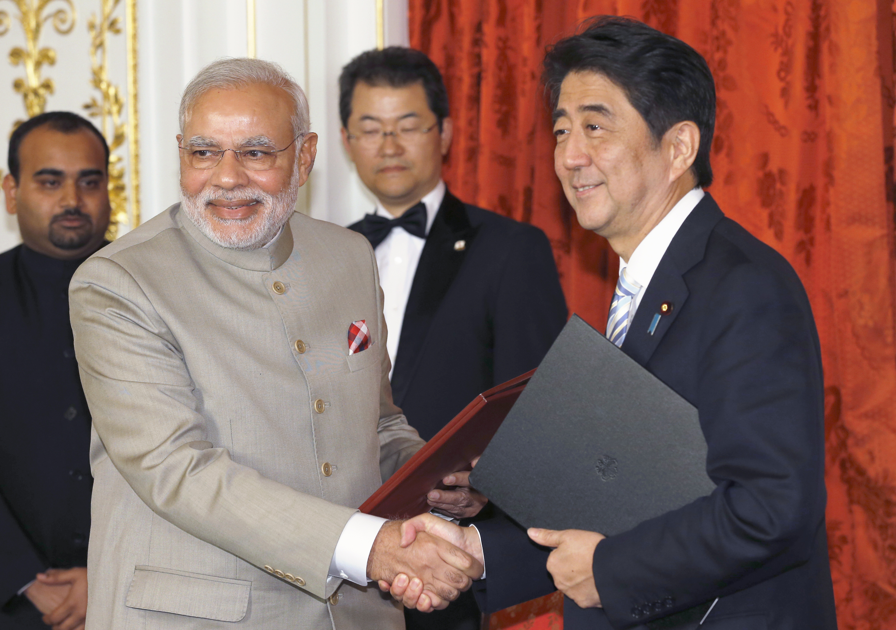 India's Prime Minister Narendra Modi, left, shakes hands with Japan's Prime Minister Shinzo Abe during a signing ceremony in Tokyo on Sept. 1, 2014 (Shizuo Kambayashi—Reuters)