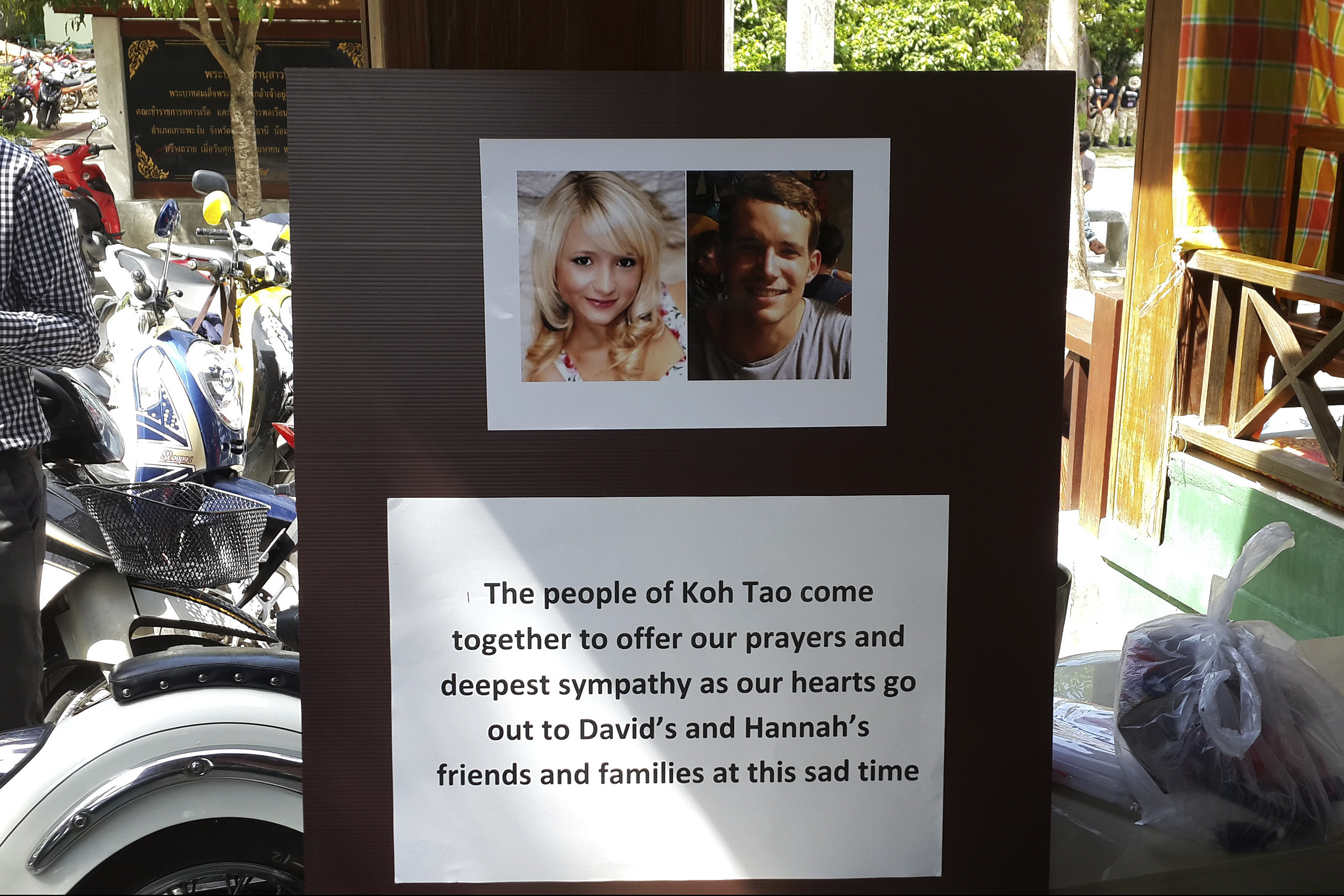 Pictures of killed British tourists David Miller and Hannah Witheridge and a message of support to their friends and families are displayed during special prayers at Koh Tao island on Sept. 18, 2014 (Sitthipong Charoenjai—Reuters)