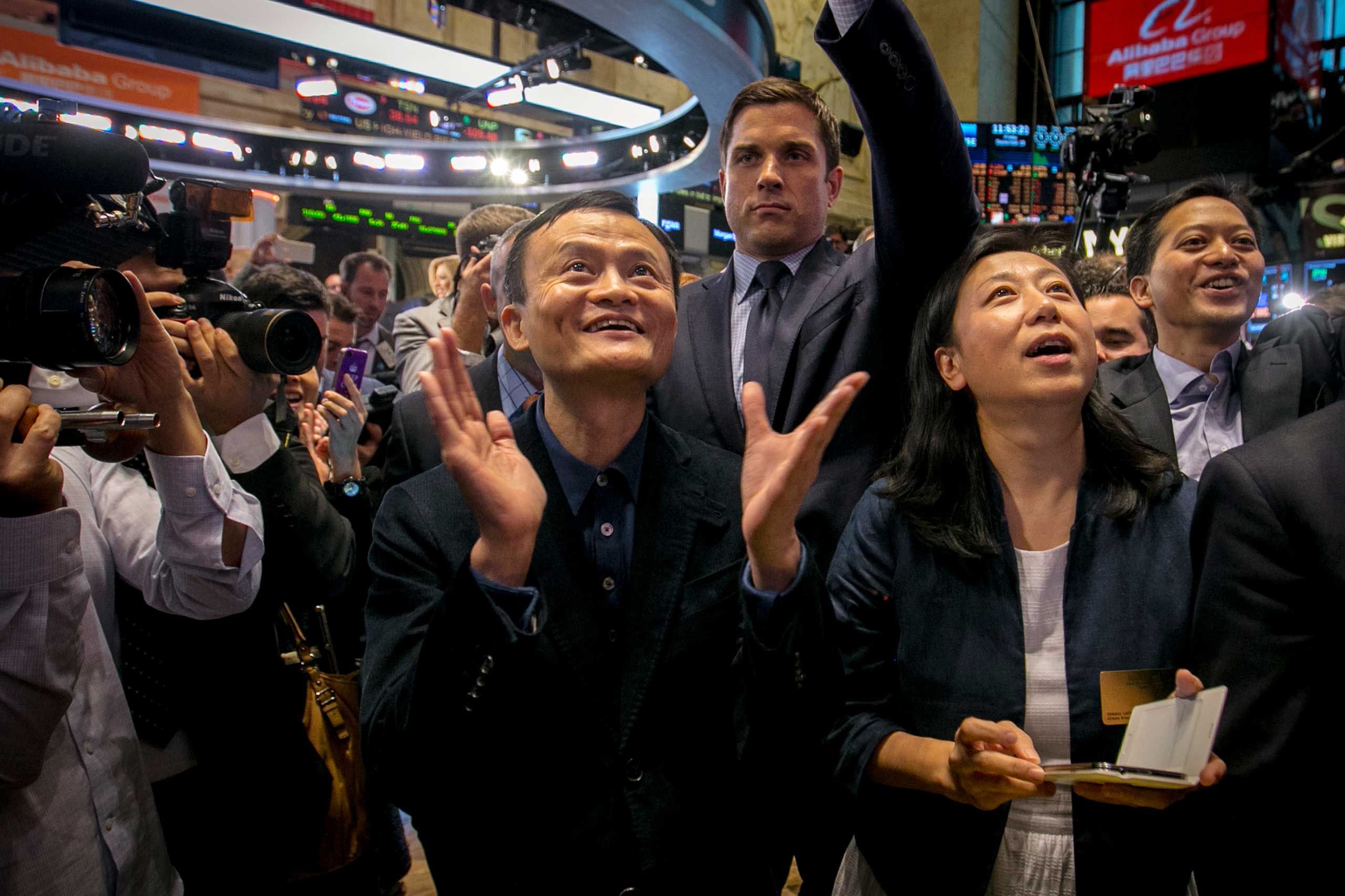 Alibaba Group Holding Ltd founder Jack Ma and Chief Financial Officer Maggie Wu react as the company's initial public offering, under the ticker "BABA", begins trading at the New York Stock Exchange in New York, Sept. 19, 2014. (Brendan McDermid—Reuters)