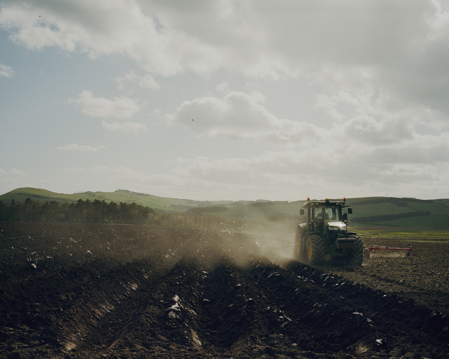 A farmer ploughing the land, Northumberland, England.