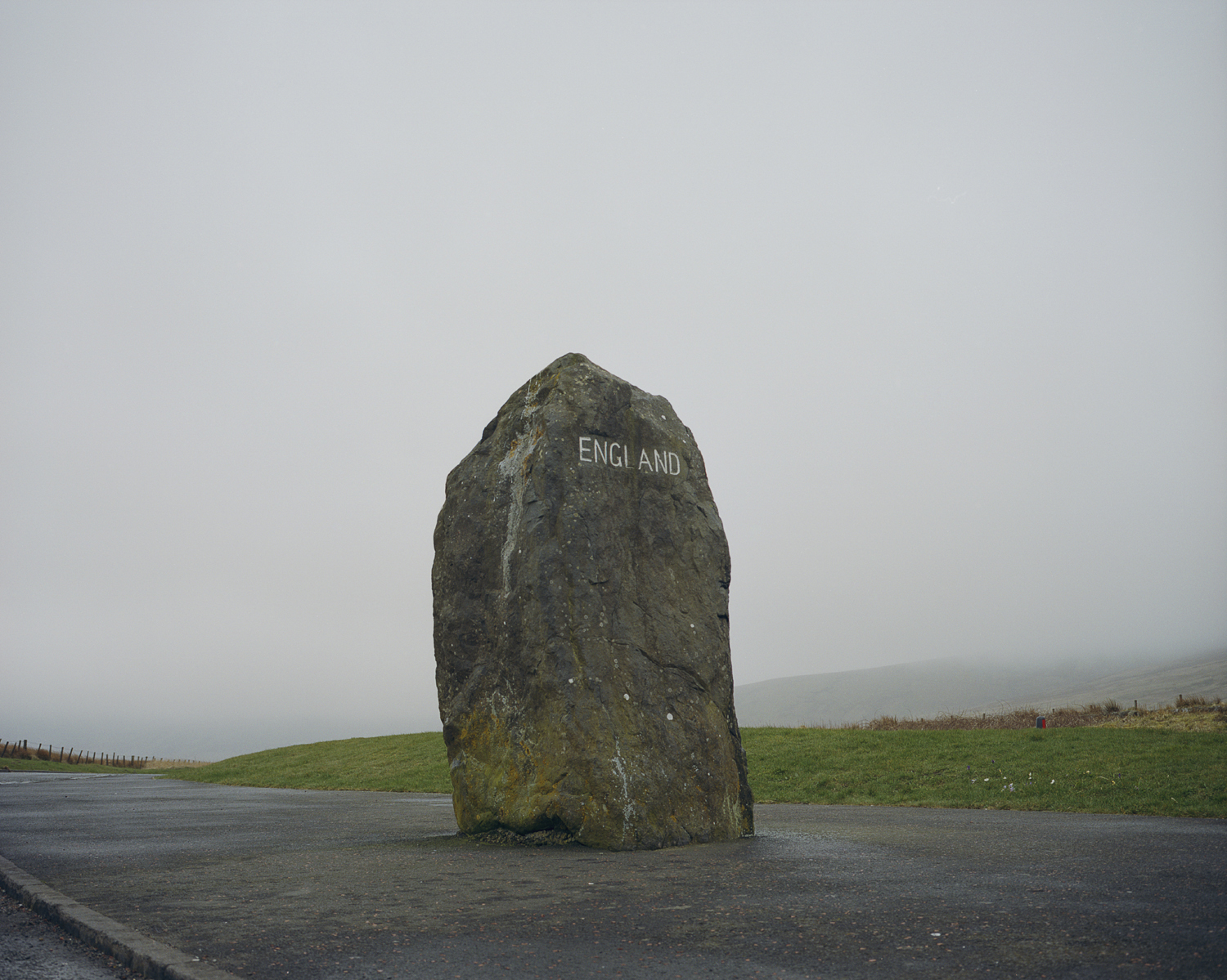 A large stone marking the English side of the border with Scotland on the A68 between Jedburgh, Scotland and Newcastle, England.