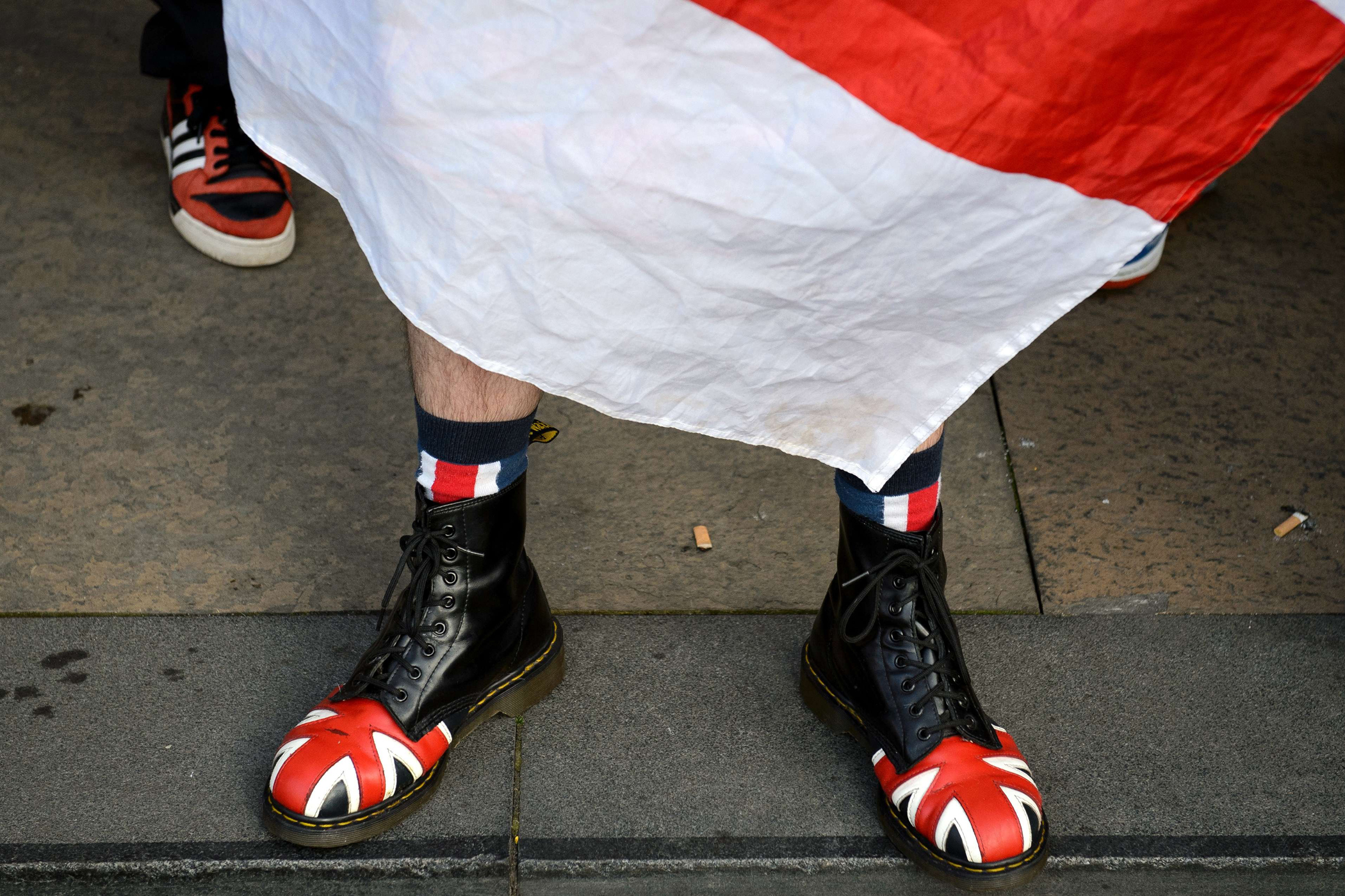 An anti-independence activist wearing shoes bearing the Union flag rallies opposite pro-independence supporters in Glasgow's George Square, in Scotland, on Sept. 17, 2014, on the eve of Scotland's independence referendum.