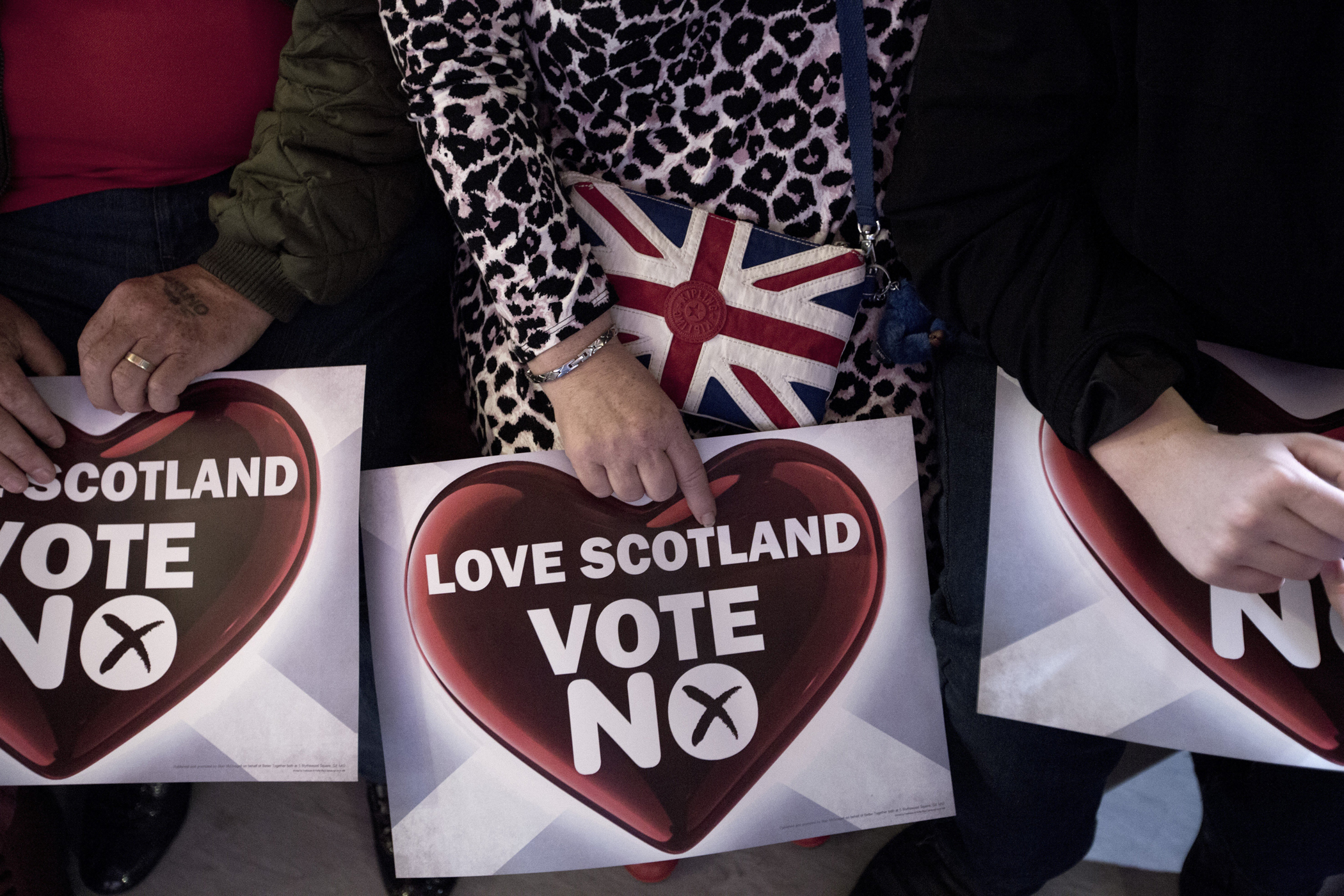 A woman with a 'Vote No' sign and a bag bearing a British flag, at an anti-Scottish independence Better Together rally at Community Central Hall, Glasgow, Sept. 17, 2014.