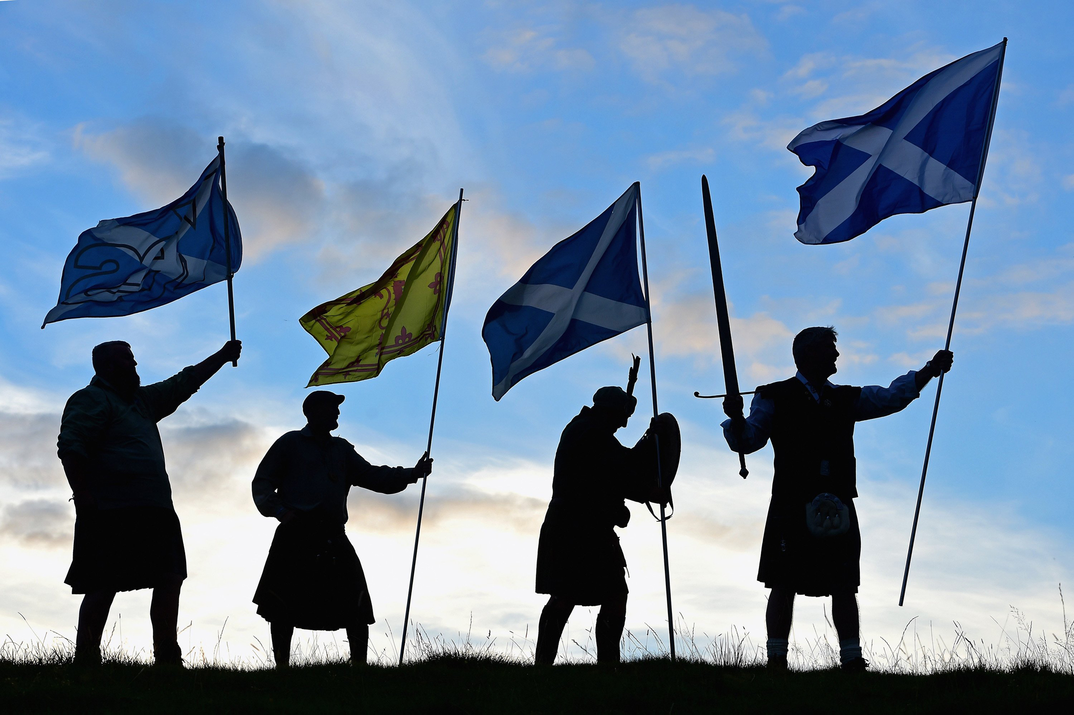 Men from King of Scots Robert the Bruce Society, hold the Scottish flags as they prepare to vote in the Scottish independence referendum on Sept 14, 2014 in Loch Lomond.