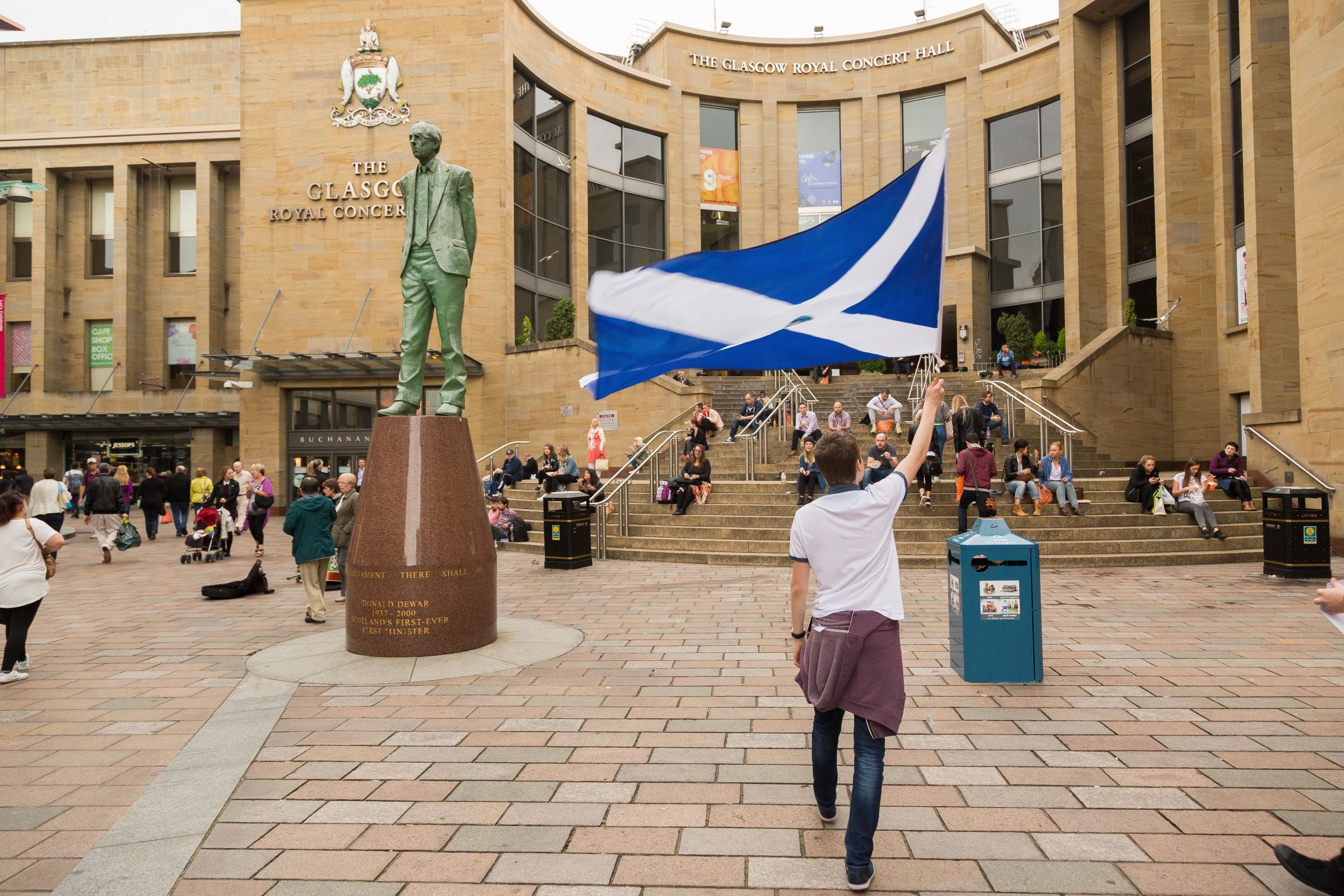 A Yes campaign supporter flies a large Scotland flag close to the statue of Donald Dewar in Buchanan Street on Sept. 4, 2014.