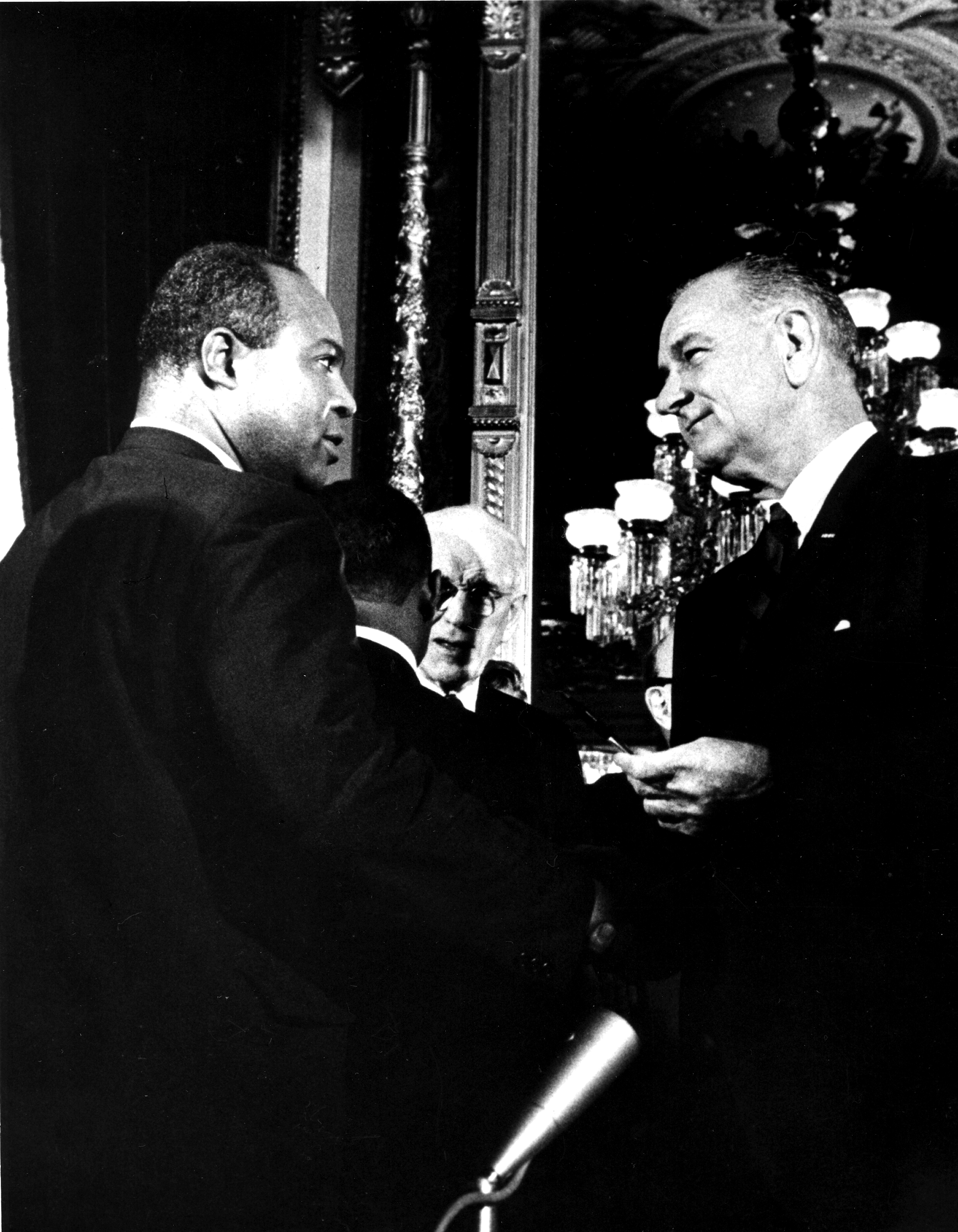 President Lyndon B. Johnson  presents one of the pens used to sign the Voting Rights Act of 1965 to the director of the Congress of Racial Equality (CORE) James L. Farmer Jr, Washington DC, August 6, 1965. (PhotoQuest—Getty Images)