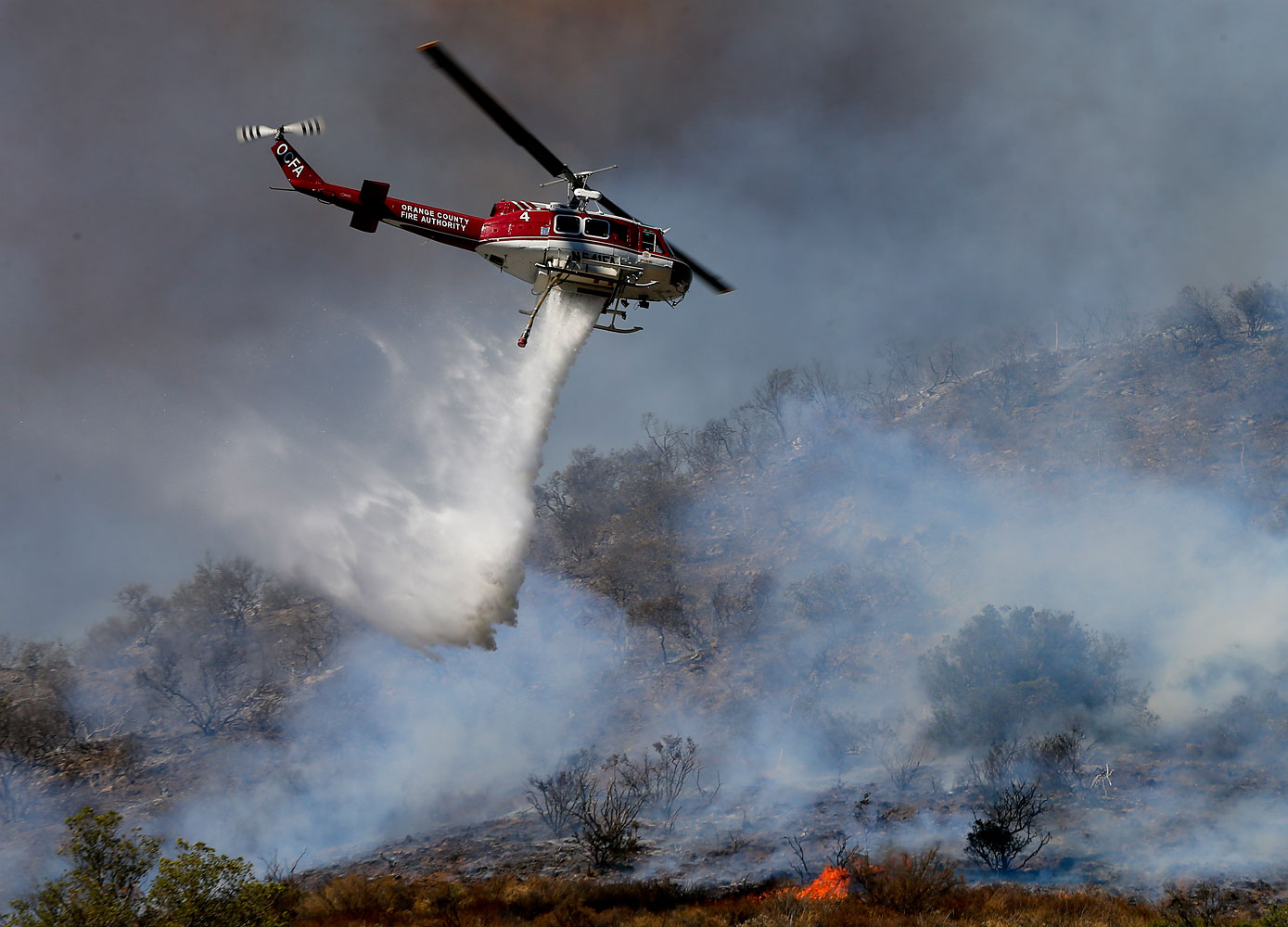 More than 280 firefighters are aided by water dropping helicopters and fixed-wing aircraft as they battle a 1,300-acre fire in Silverado Canyon, Calif., on Sept. 12, 2014. (Mark Boster—Los Angeles Times/AP)