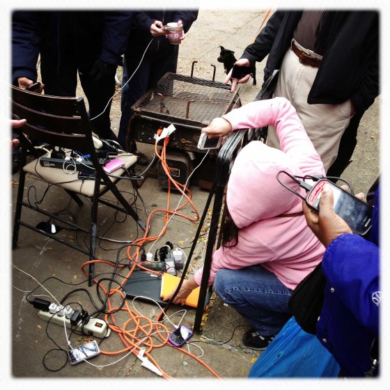 New Yorkers charge their mobile phones with generators provided by Percy's Tavern, located on Avenue A and 13th Street in Manhattan