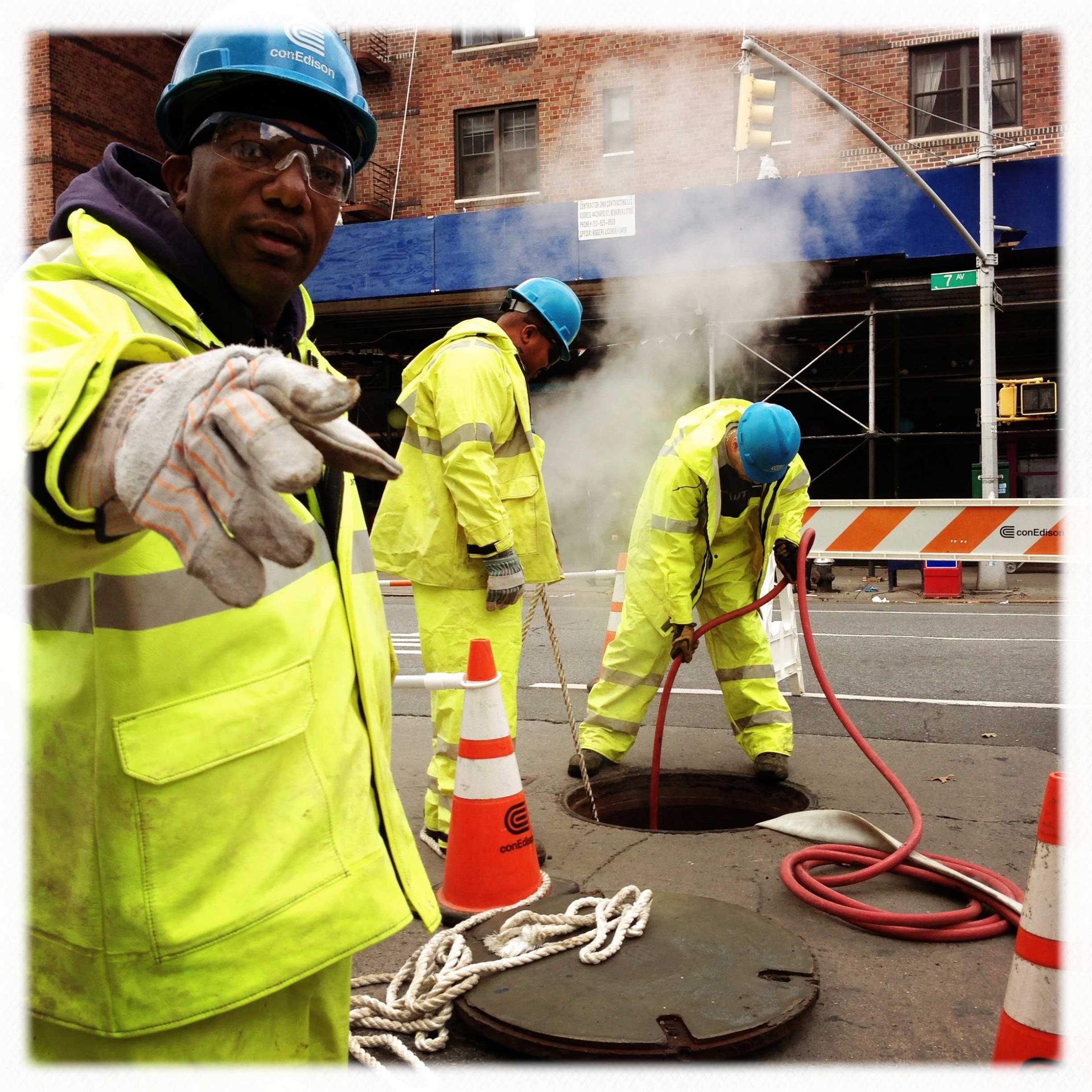 Con Edison workers clean a manhole on 7th Avenue and 22nd Street in Manhattan