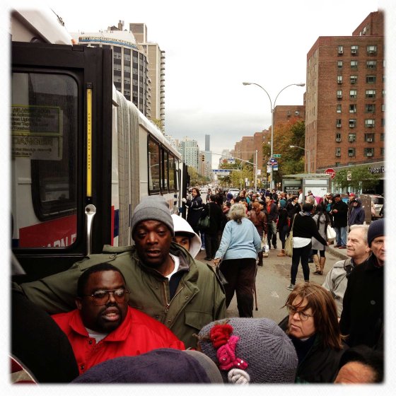 New Yorkers wait to board a crowded city bus on 1st Avenue and 14th Street in Manhattan