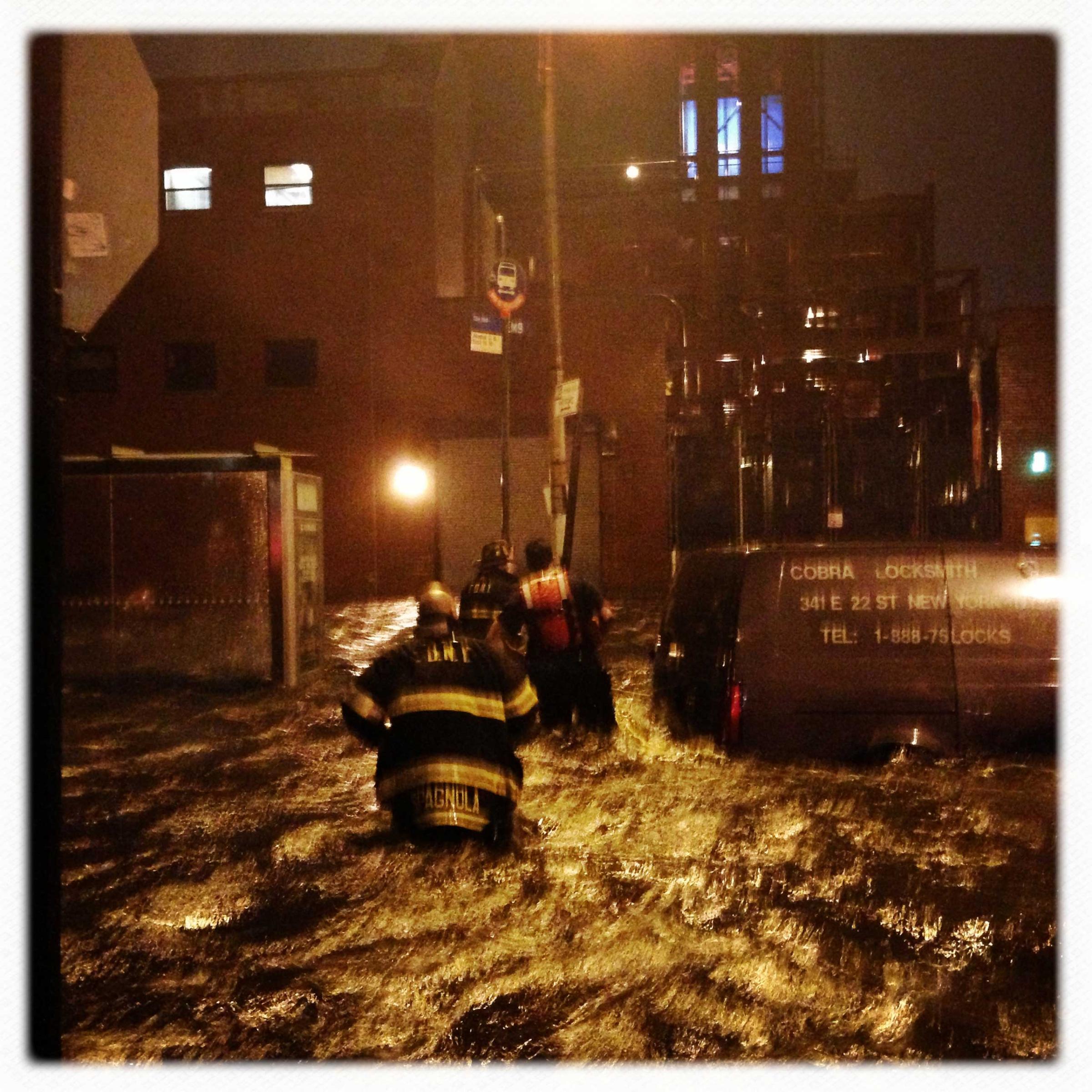 Firemen search for people trapped in their cars at 14th Street and Avenue C in Manhattan