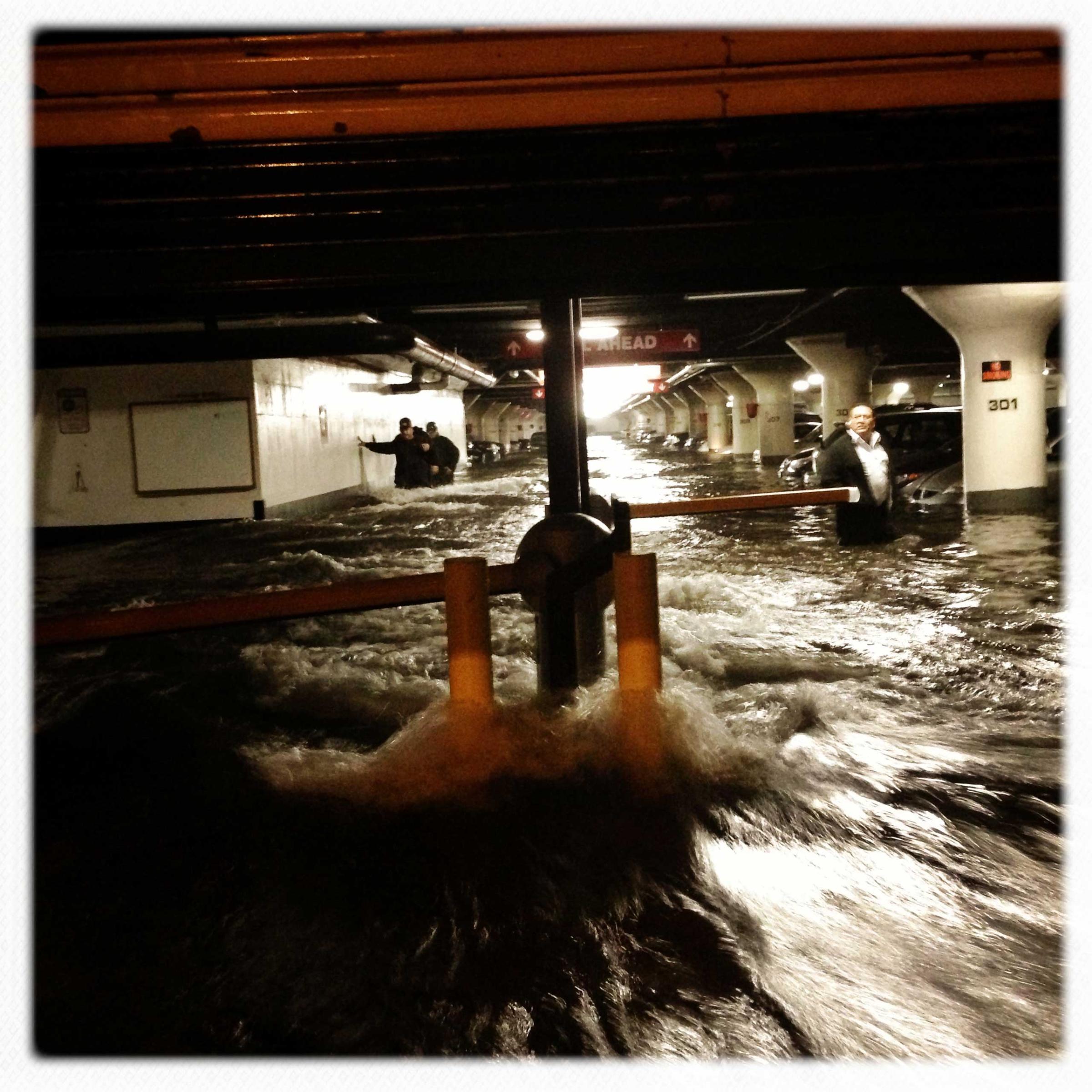 Water pours into a parking garage on Avenue C in Manhattan