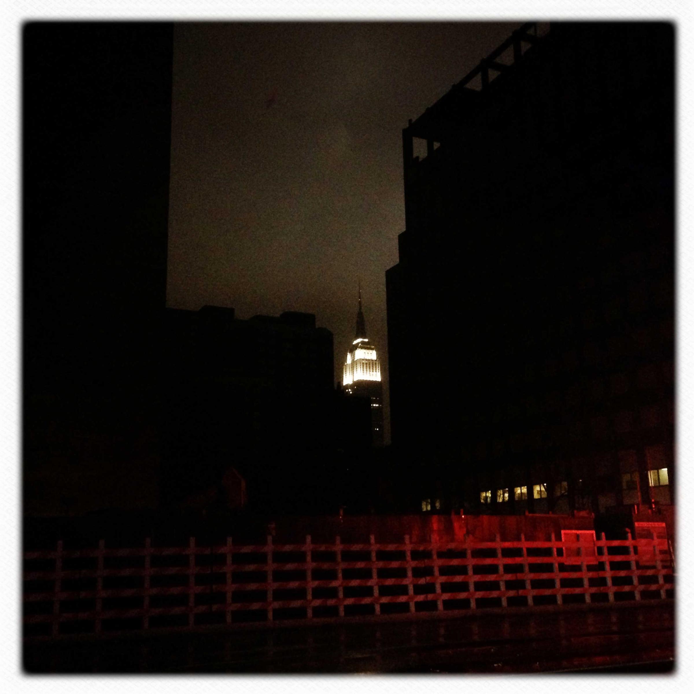 With much of lower and midtown Manhattan in the dark, the Empire State Building lights up the sky
