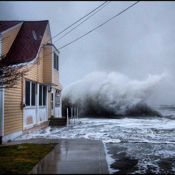 Storm surges flood the streets during low tide in Milford, Conn.