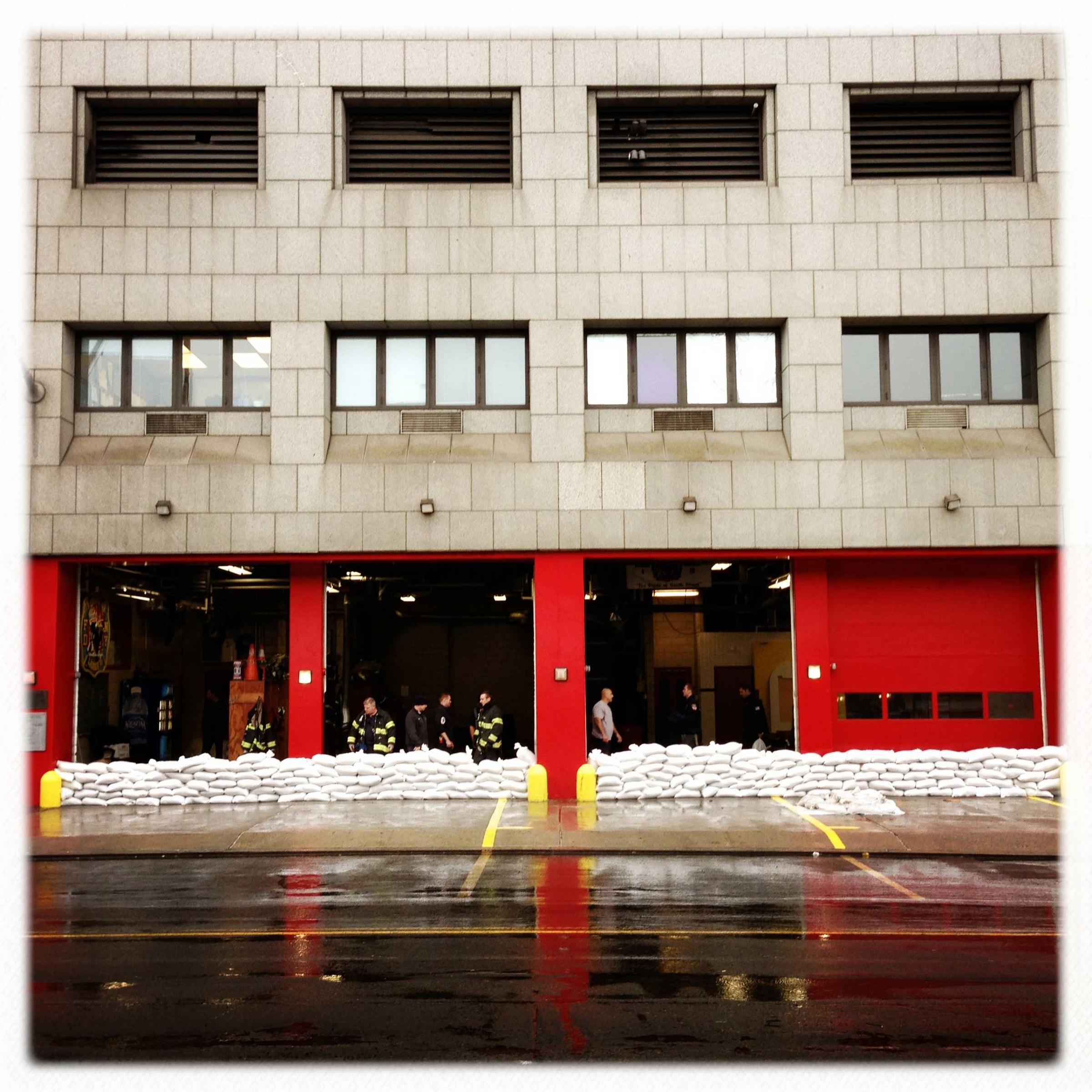 The fire department on South Street, in Manhattan, prepares to meet the rising water