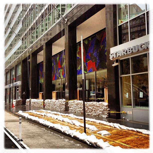 Sandbags line the entrance to an office building on Broadway in downtown Manhattan
