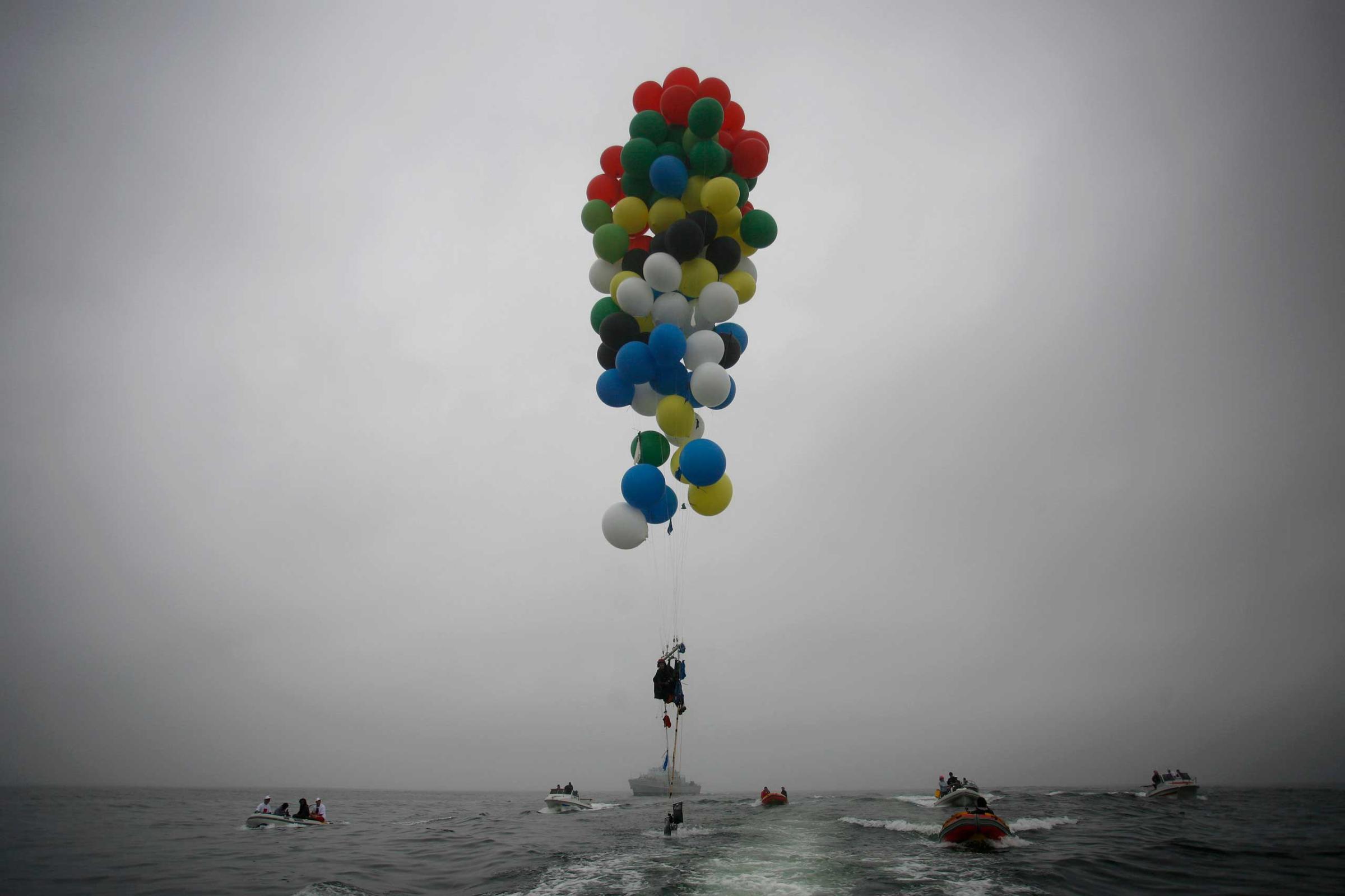 Silver-Vallance floats above the sea using helium filled balloons from the airfield of Robben Island across the Atlantic Ocean in Cape Town