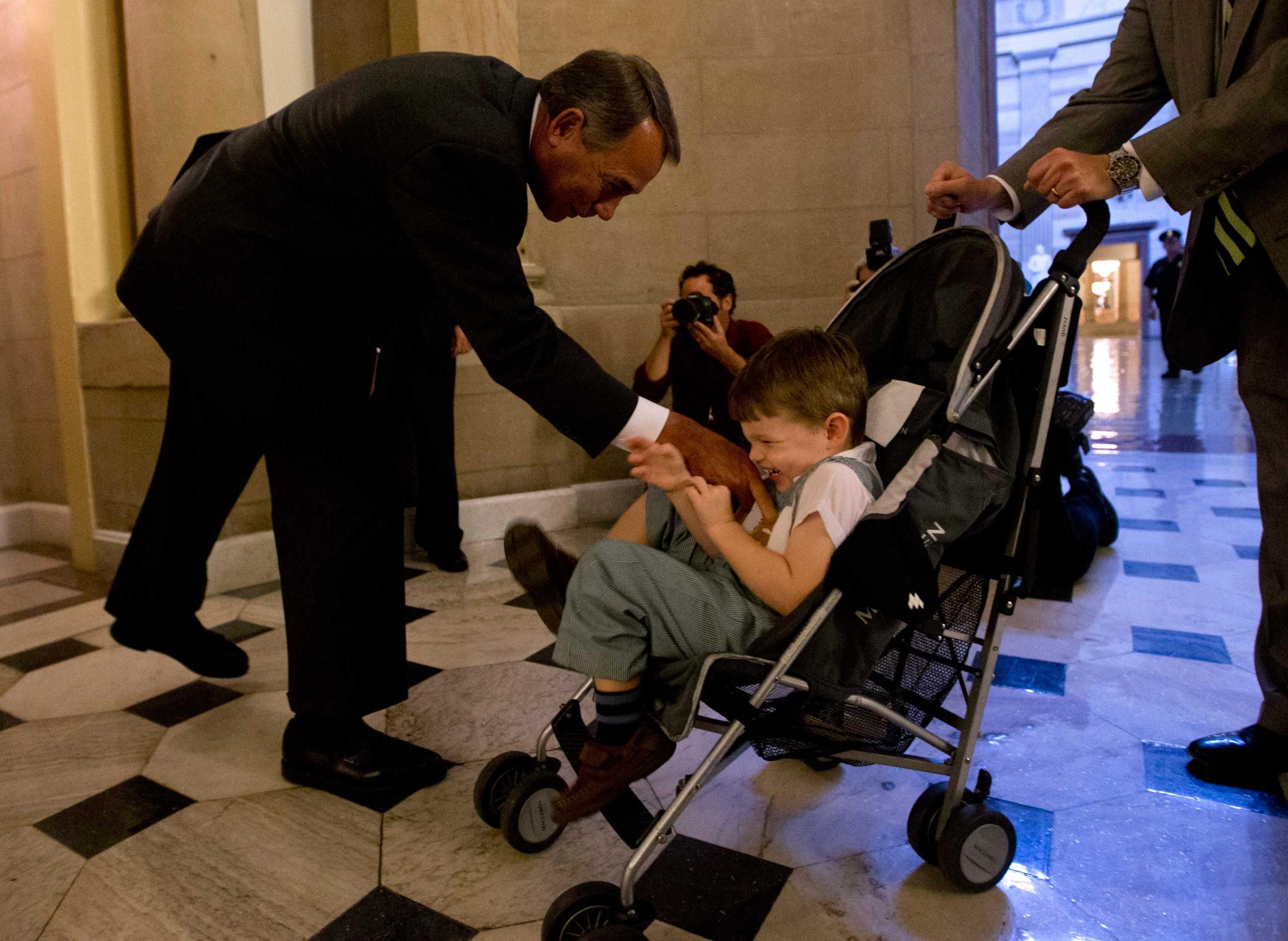 U.S. House Speaker John Boehner tickles John Griffin III in Washington