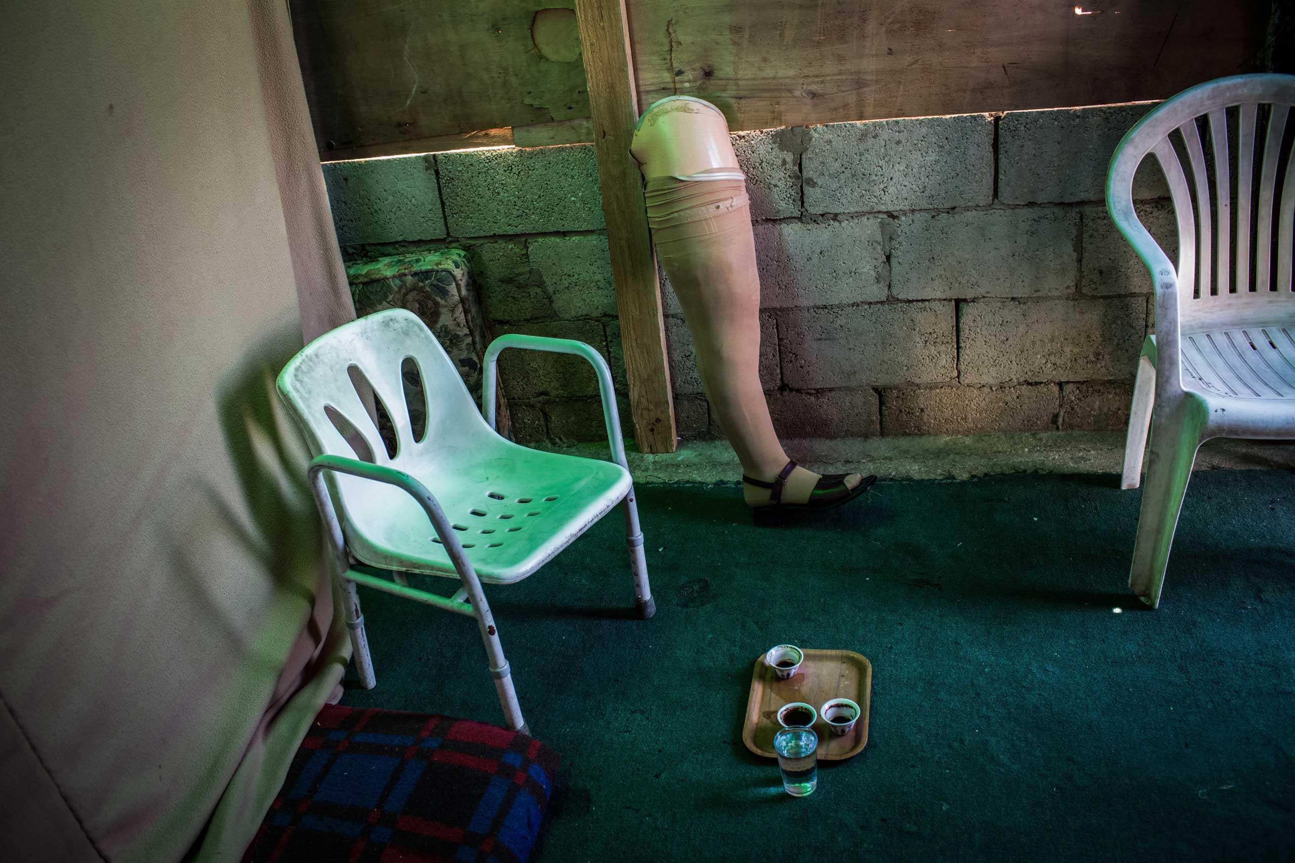 A prosthetic belonging to Reem, 34, stands in her family’s space in Zahle, Lebanon, June 26, 2014. She lost her leg, home, husband and daughter in October 2012 when a shell hit their house in Hama, Syria.