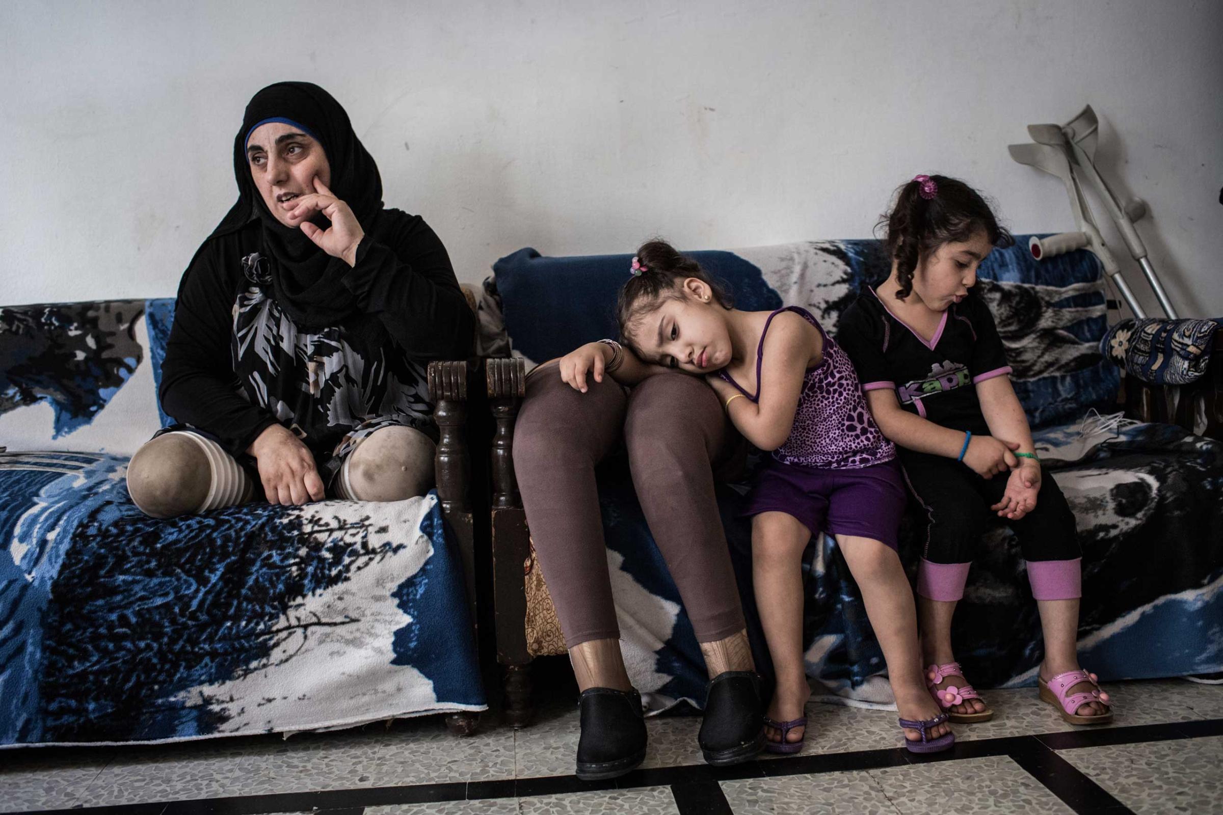 Hasna and her nieces at home in Tripoli, Lebanon, on June 11, 2014. A bomb in Syria killed her husband and kids in 2012; she received two prosthetics legs. “It was hard and difficult but now I always try to focus on the positive things."
