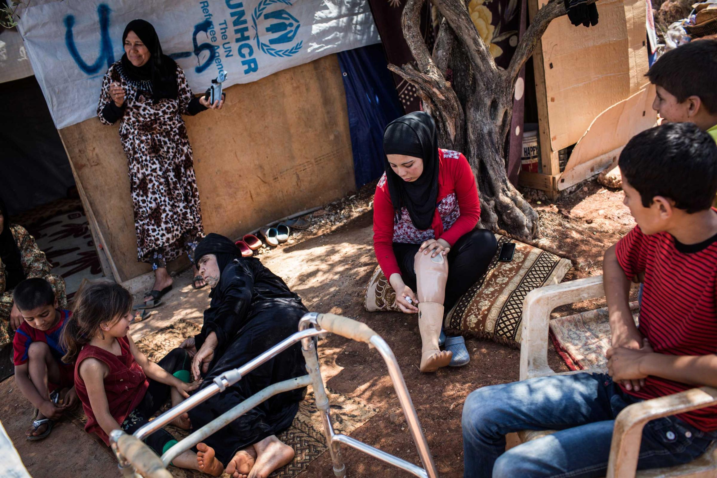 Fatima, 15, at an informal settlement near Tripoli, Lebanon, June 24, 2014. She was going to Homs in 2011 with her father and brother when a bomb fell. She was depressed after receiving an ill-fitting prosthetic but later got a better one.