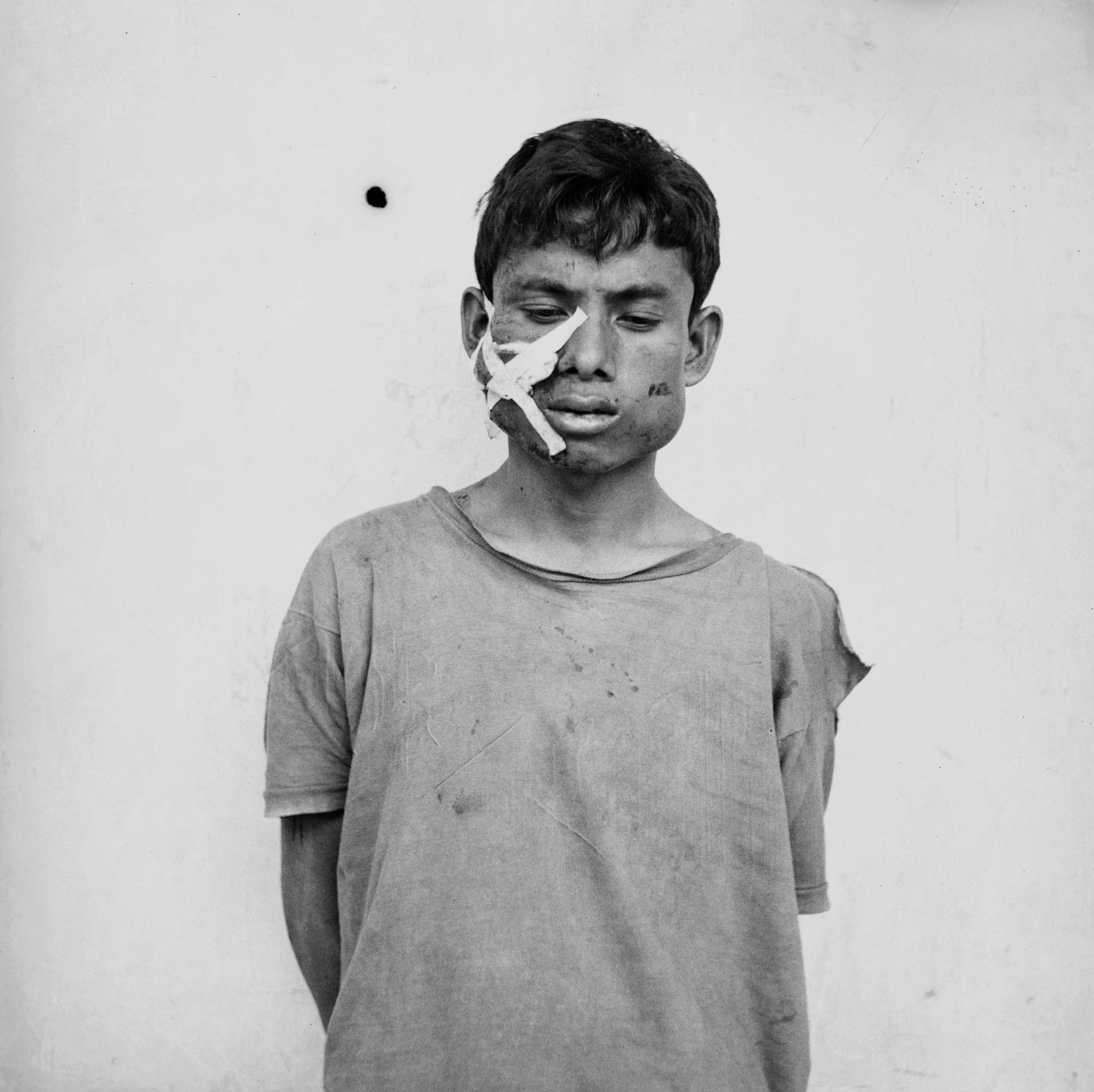 An unidentified prisoner suspected of crimes against Pol Pot's regime photographed while being checked in at the S-21 death camp in Cambodia, c. 1975-78.