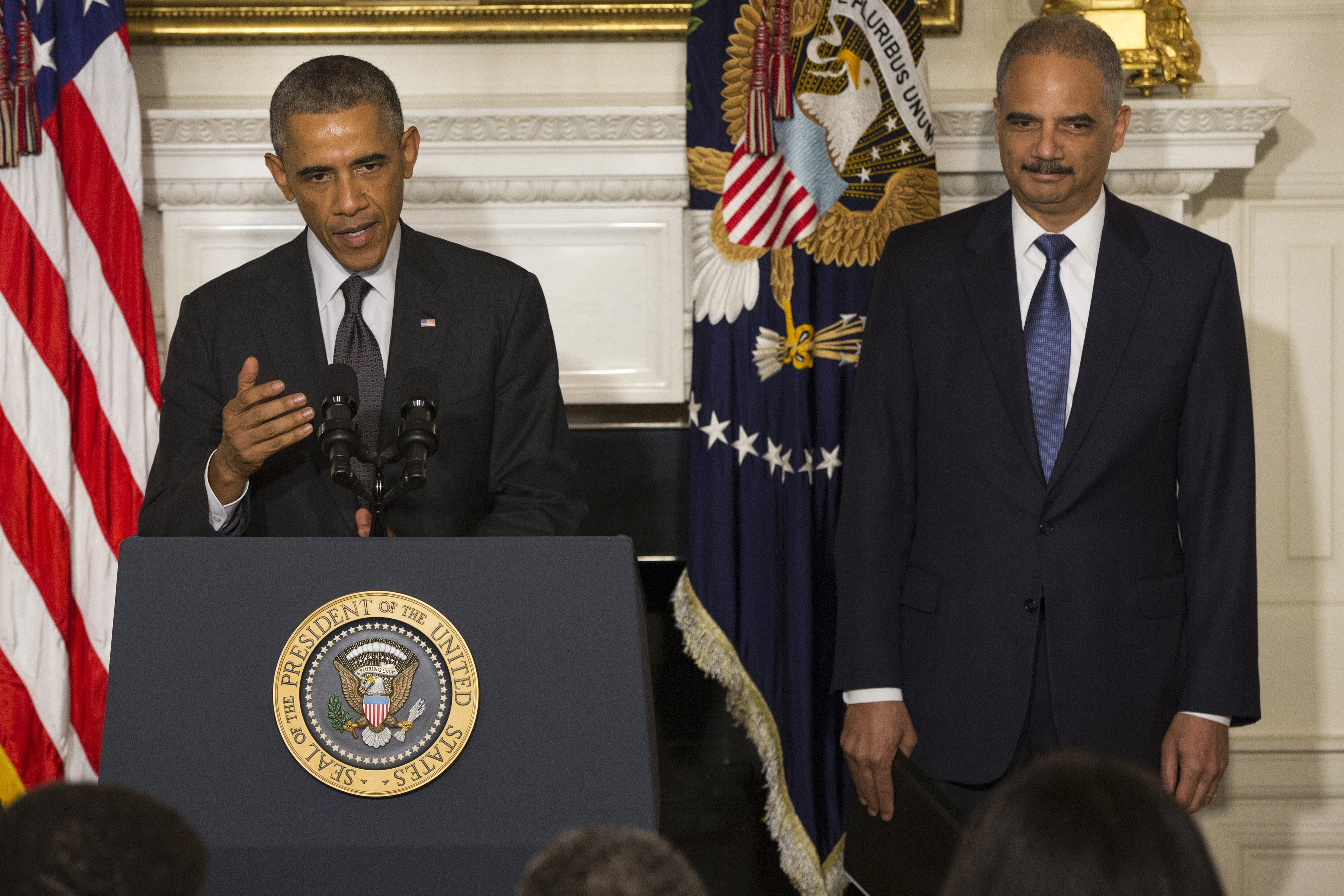 President Barack Obama, accompanied by Attorney General Eric Holder, speaks in the State Dining Room of the White House in Washington, Thursday, Sept. 25, 2014, to announce Holder is resigning. (Evan Vucci&mdash;AP)