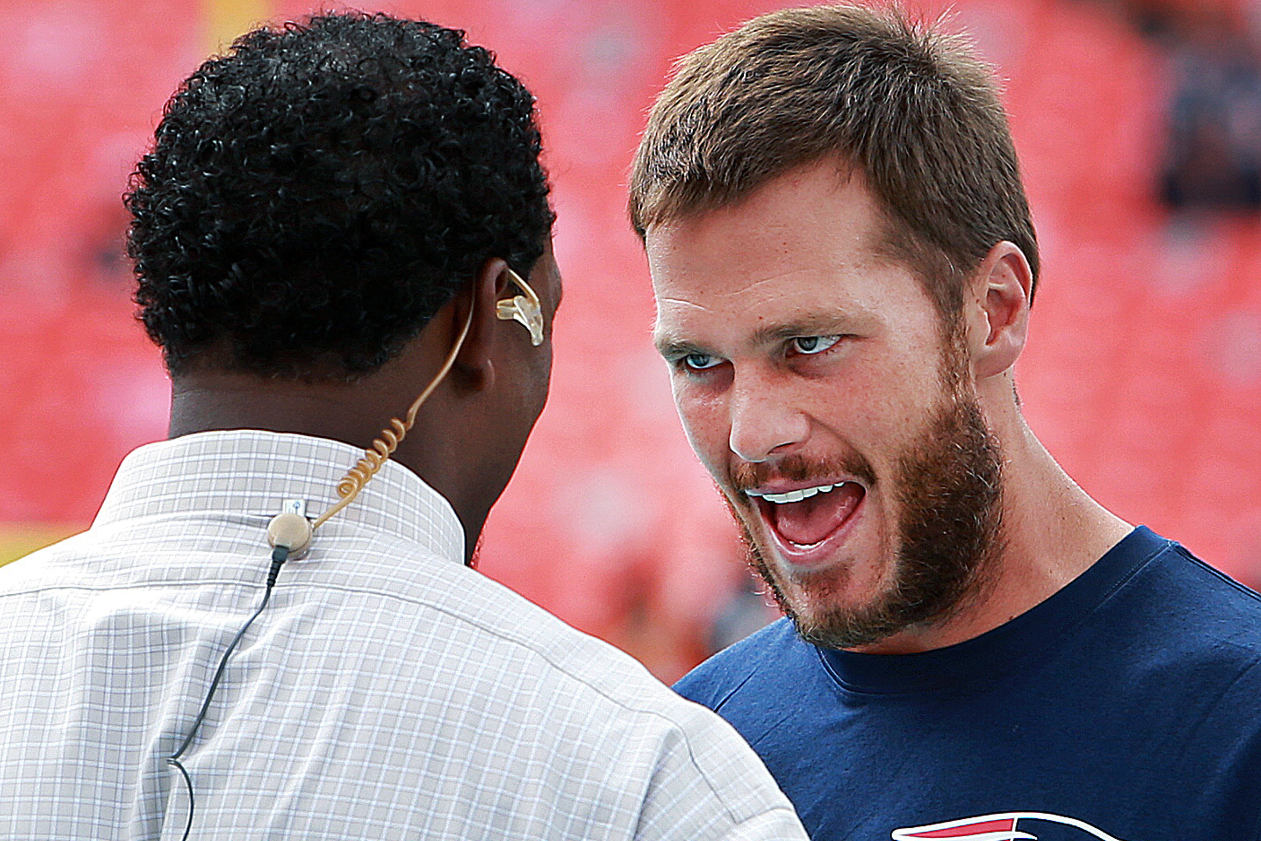 Patriots quarterback Tom Brady, right, chatted with former teammate Willie McGinest, left, now of the NFL Network before the Patriots faced the Miami Dolphins on Sept. 14. (Boston Globe—Boston Globe via Getty Images)