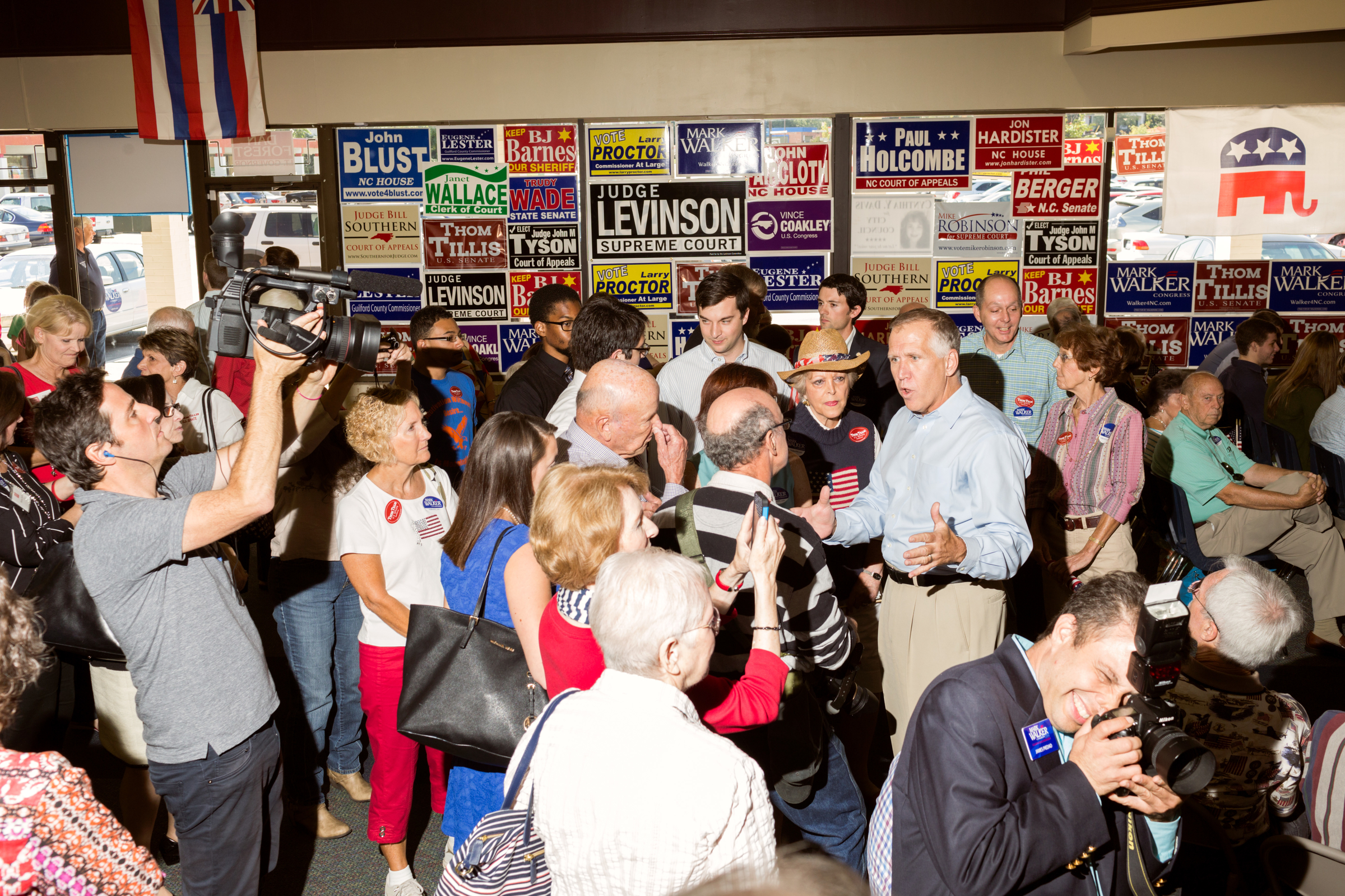 US Senate candidate Thom Tillis, right in blue shirt, greets and speaks to rally attendees at the Guildford County Republican Party headquarters in Greensboro, N.C. on Sept. 20, 2014. (Jeremy M. Lange for TIME)