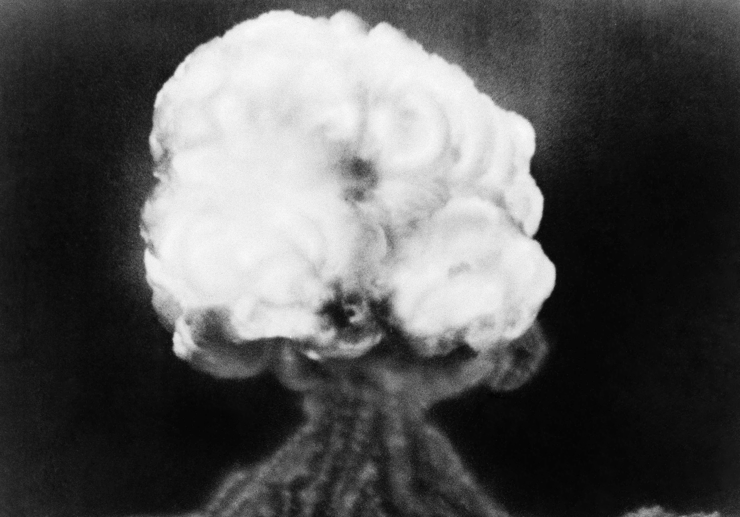 This is the mushroom cloud of the first atomic explosion at Trinity Test Site, New Mexico on July 16, 1945.  It left a half-mile wide crater, ten feet deep at the vent and the sand within the crater had been burned and boiled into a highly radioactive, jade-green, glassy crust. (AP)