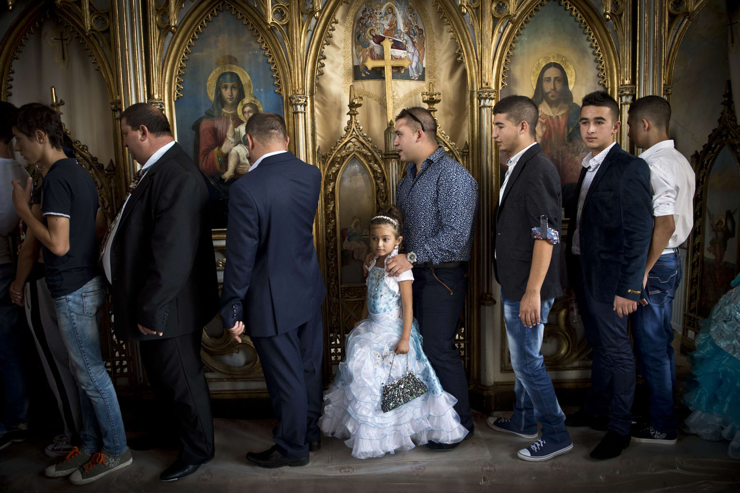 Sept. 8, 2014. People pass by icons during a religious service at the Bistrita Monastery in Costesti, Romania.