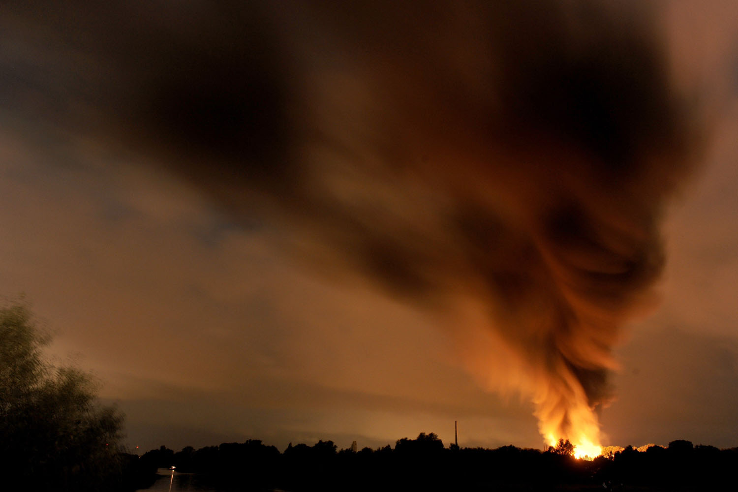 Sept. 9, 2014. Smoke rises in the sky as a factory is burning after an explosion in Ritterhude, western Germany. According to local media an explosion occured earlier in the evening at a chemical plants area where lacquer companies Organo Fluid and Bergolin have sites.