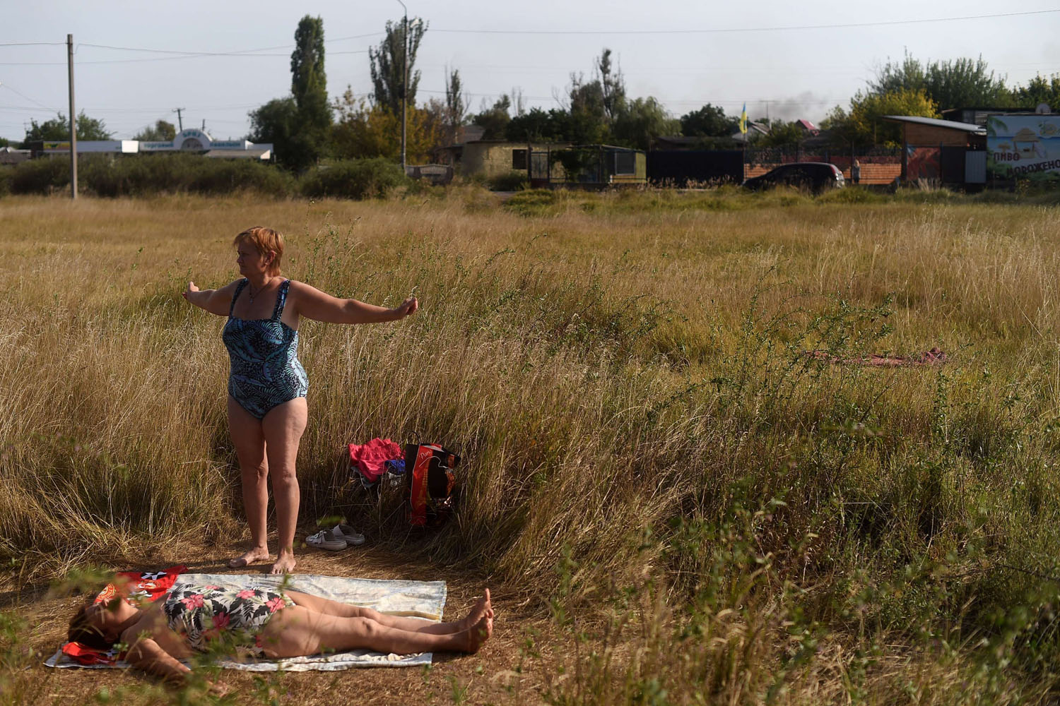 Sept. 7, 2014. 
                              Women sunbathe by a lake in the eastern Ukrainian city of Slavyansk, north of Donetsk. Fighting around two flashpoint cities in eastern Ukraine rattled a tenuous truce between government troops and pro-Russian rebels less than 48 hours after it came into force.