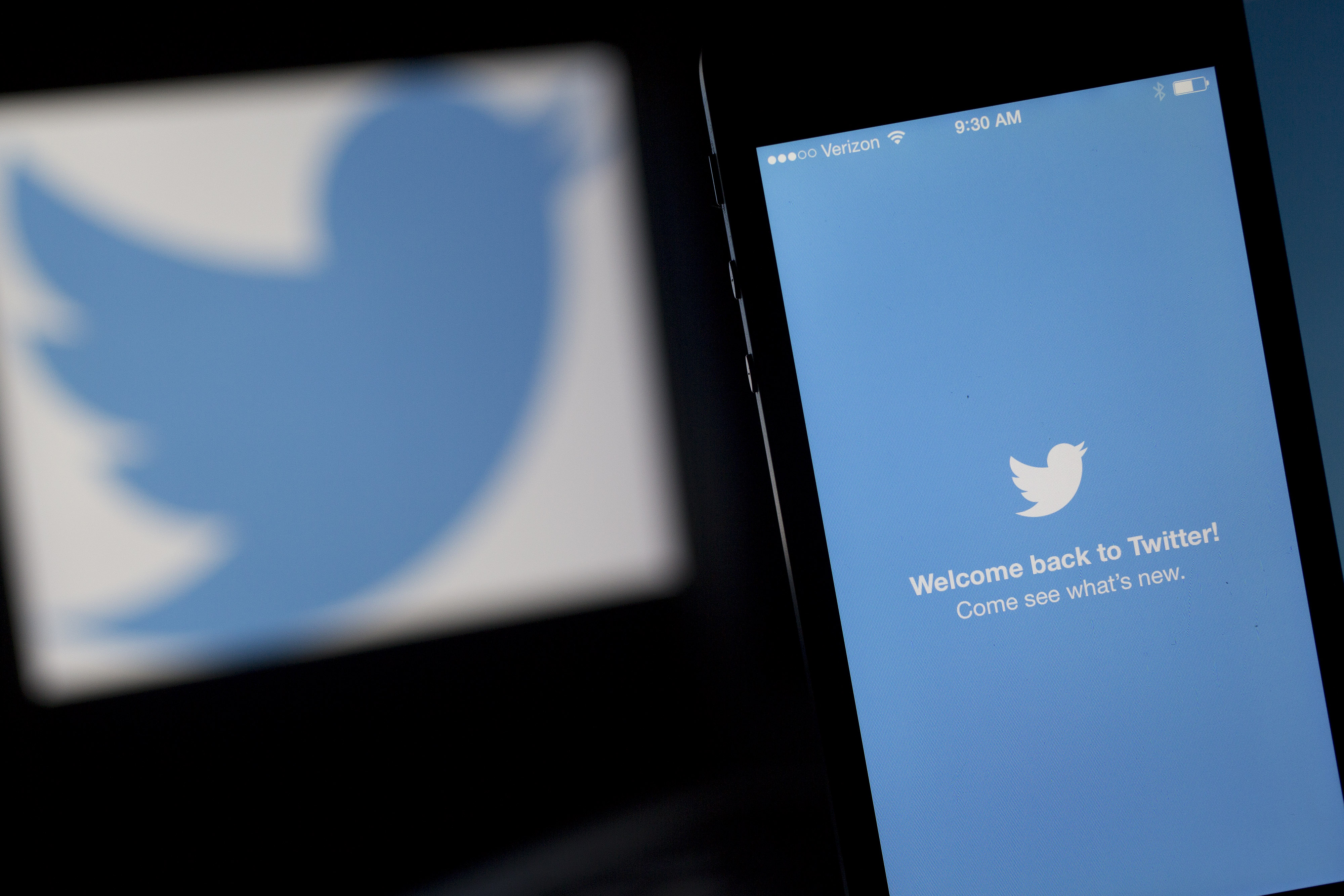 The Twitter Inc. application and logo are displayed on a laptop computer and Apple Inc. iPhone 5s in this arranged photograph in Washington, D.C., U.S., on Friday, April 25, 2014. (Bloomberg/Getty Images)