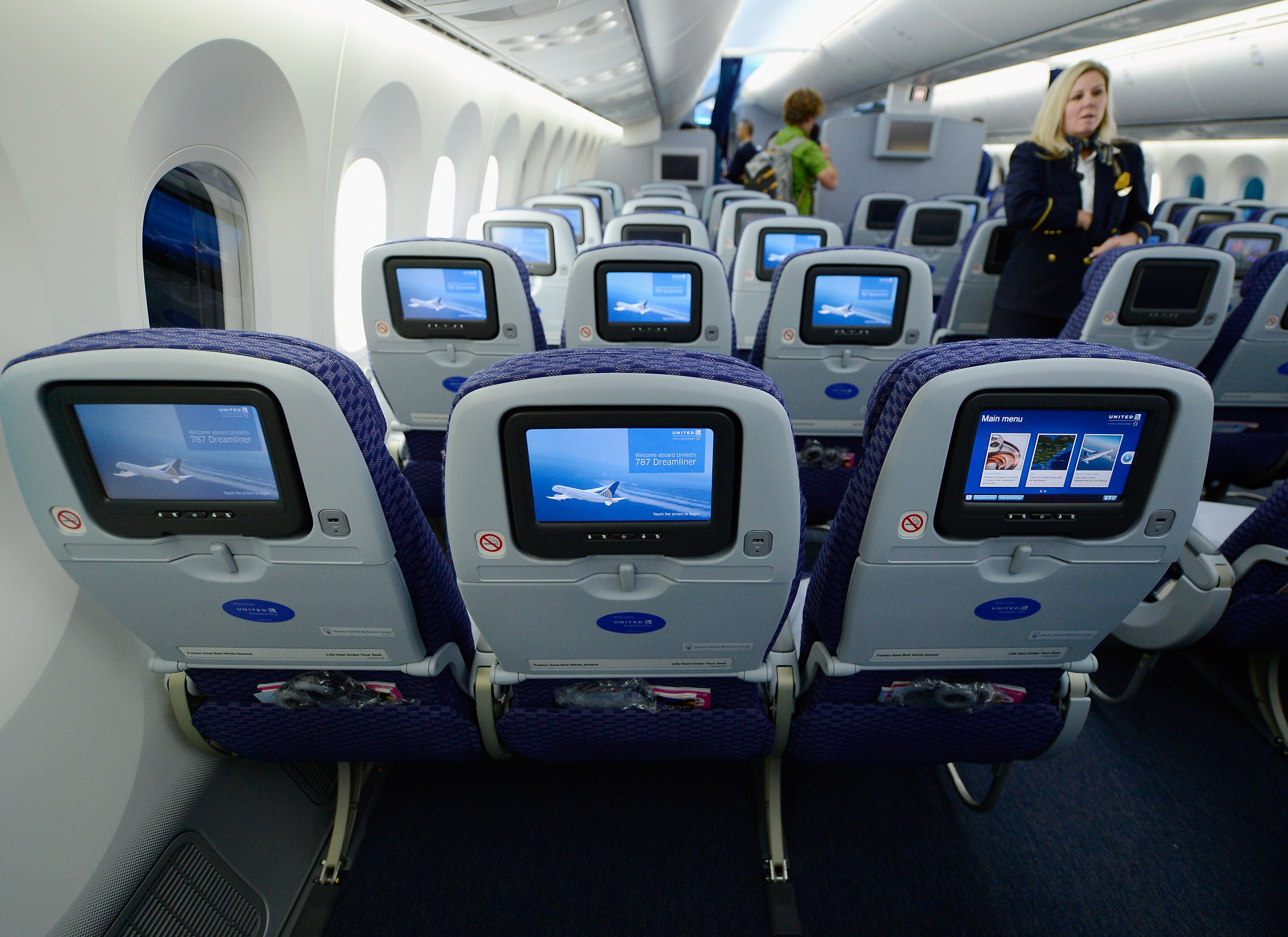 United Airlines flight attendant Tina looks at personal entertainment systems on the new Boeing 787 Dreamliner during a tour of the jet at Los Angeles International Airport on Nov. 30, 2012. (Kevork Djansezian—Getty Images)