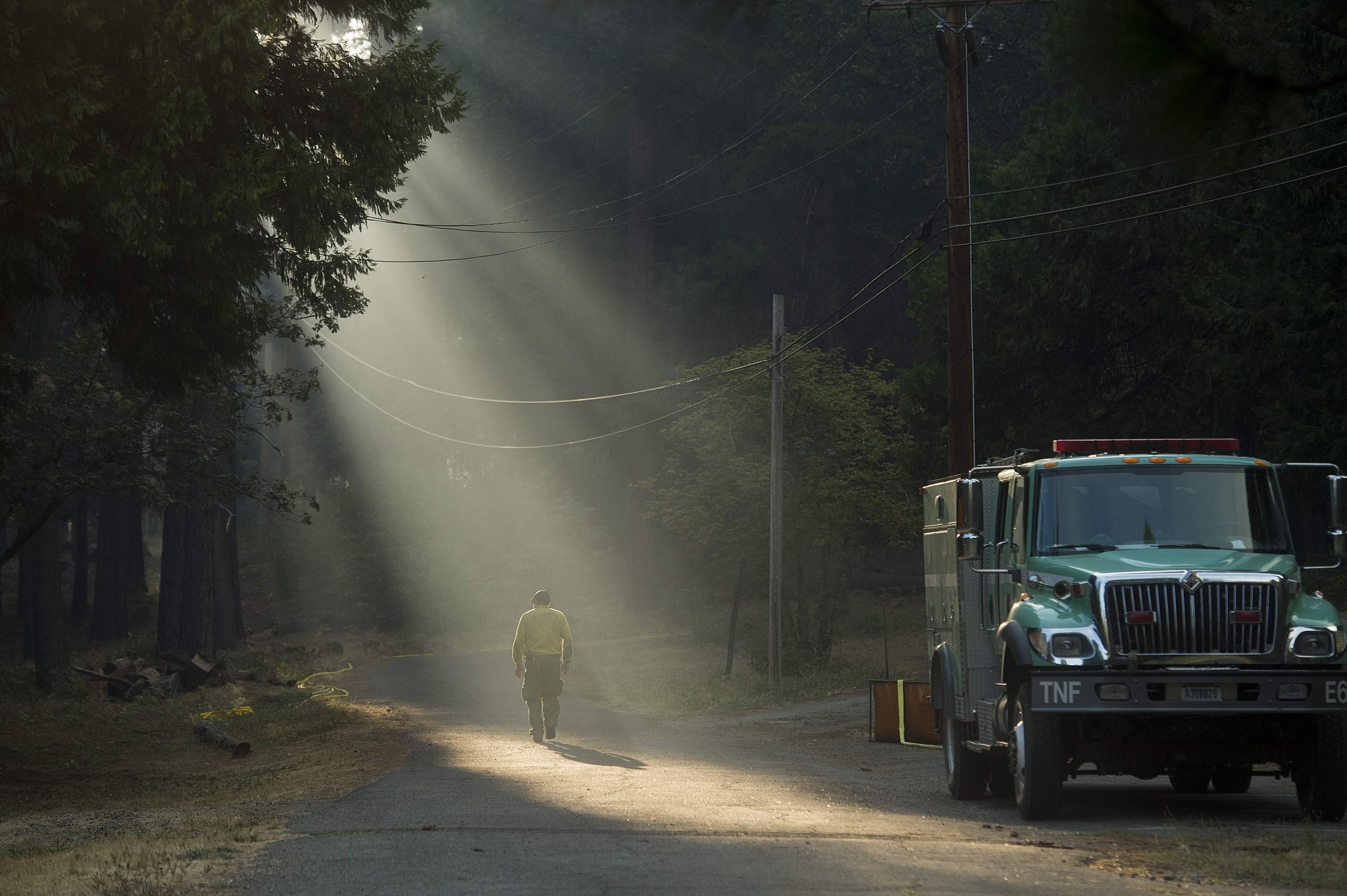 A firefighter walks through smoke while battling the King Fire near Fresh Pond, California September 17, 2014.