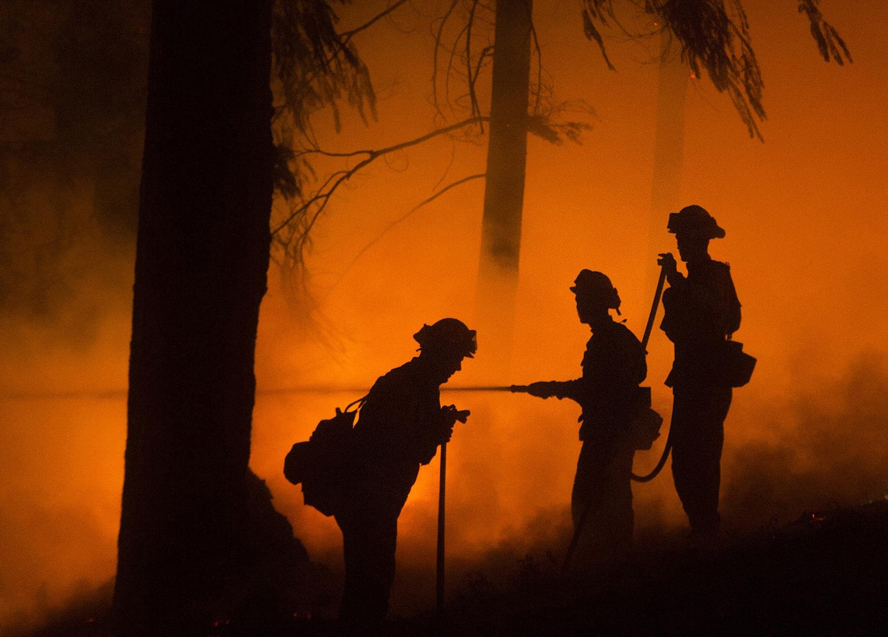 Firefighters battle the King Fire in Fresh Pond, California