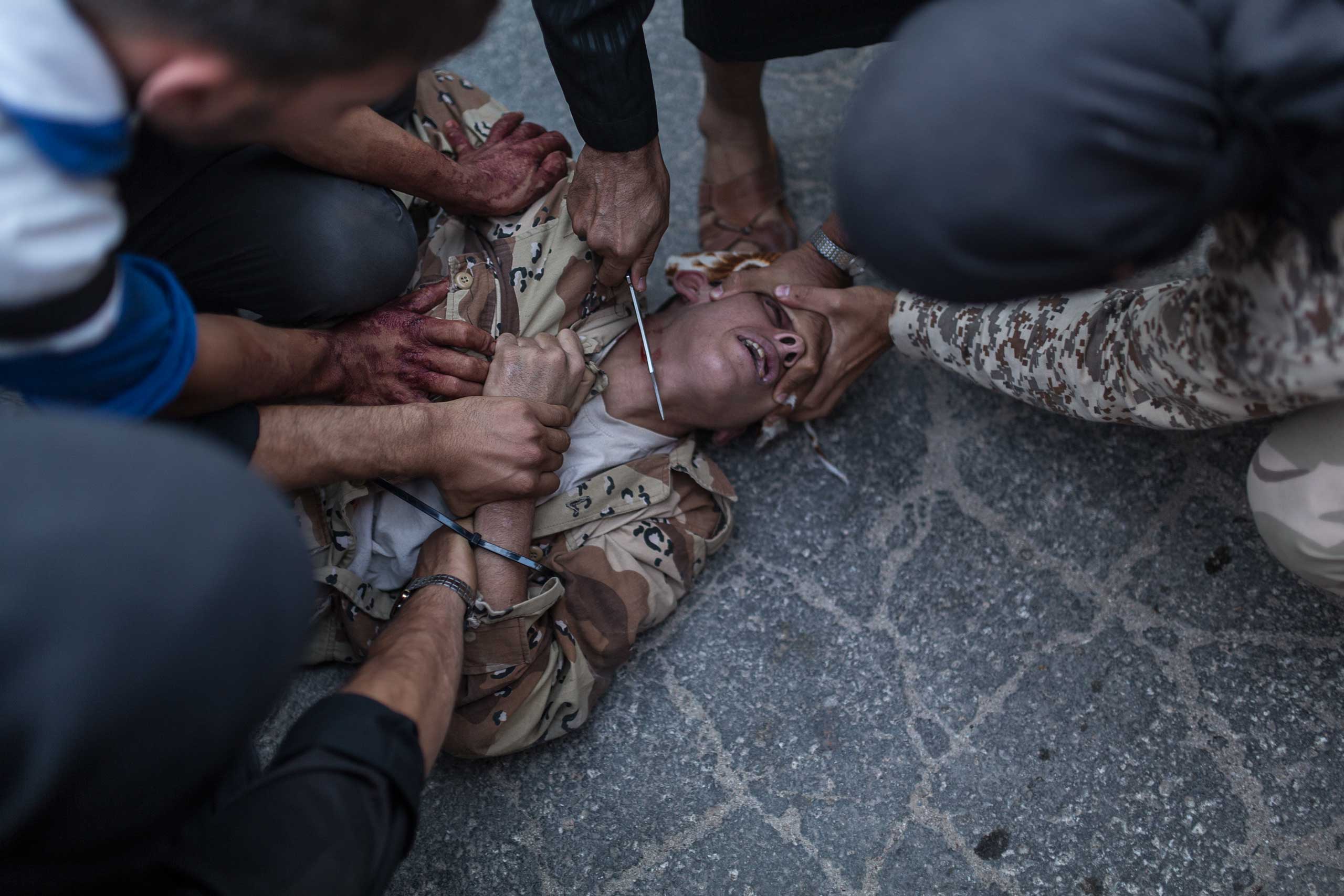 A young Syrian man is executed by ant-regime rebels in the town of Keferghan, near Aleppo, on August 31, 2013.