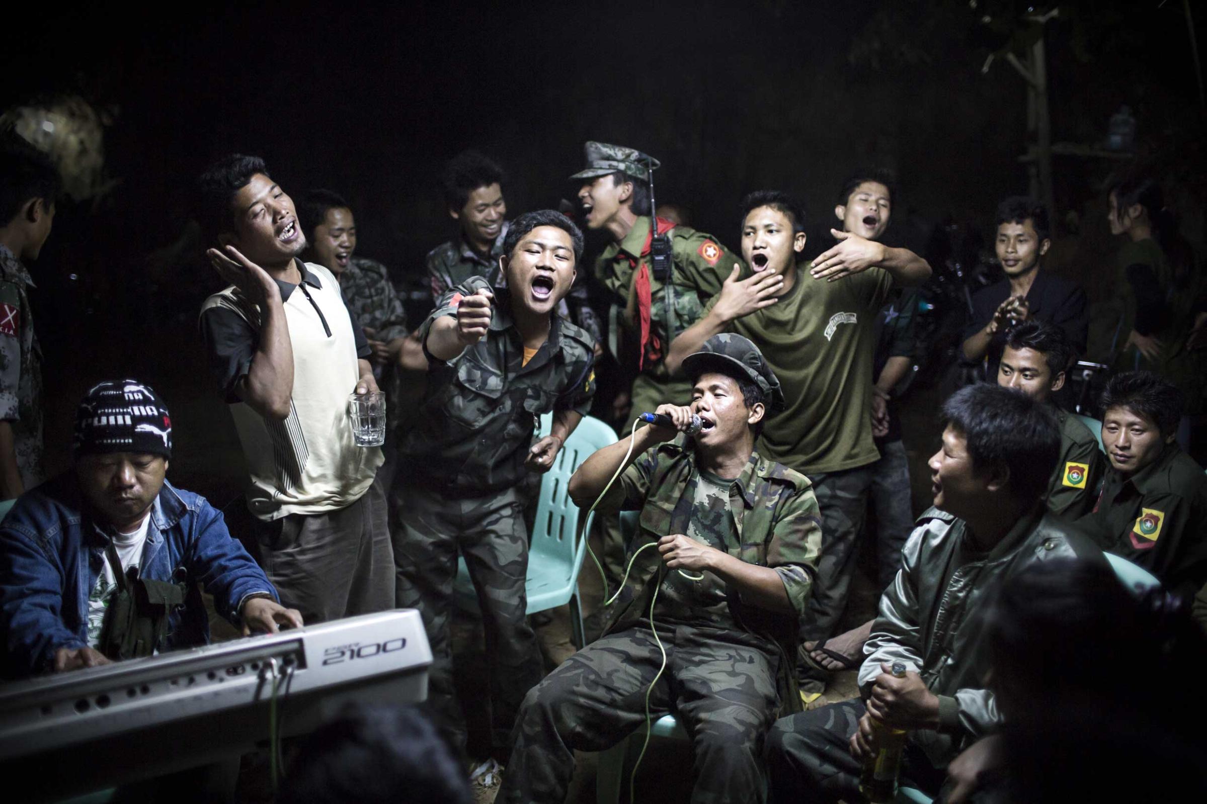 1st Prize Daily Life Single. 15 March 2013, Burma. Kachin Independence Army fighters are drinking and celebrating at a funeral of one of their commanders who died the day before. The city is under siege by the Burmese army.