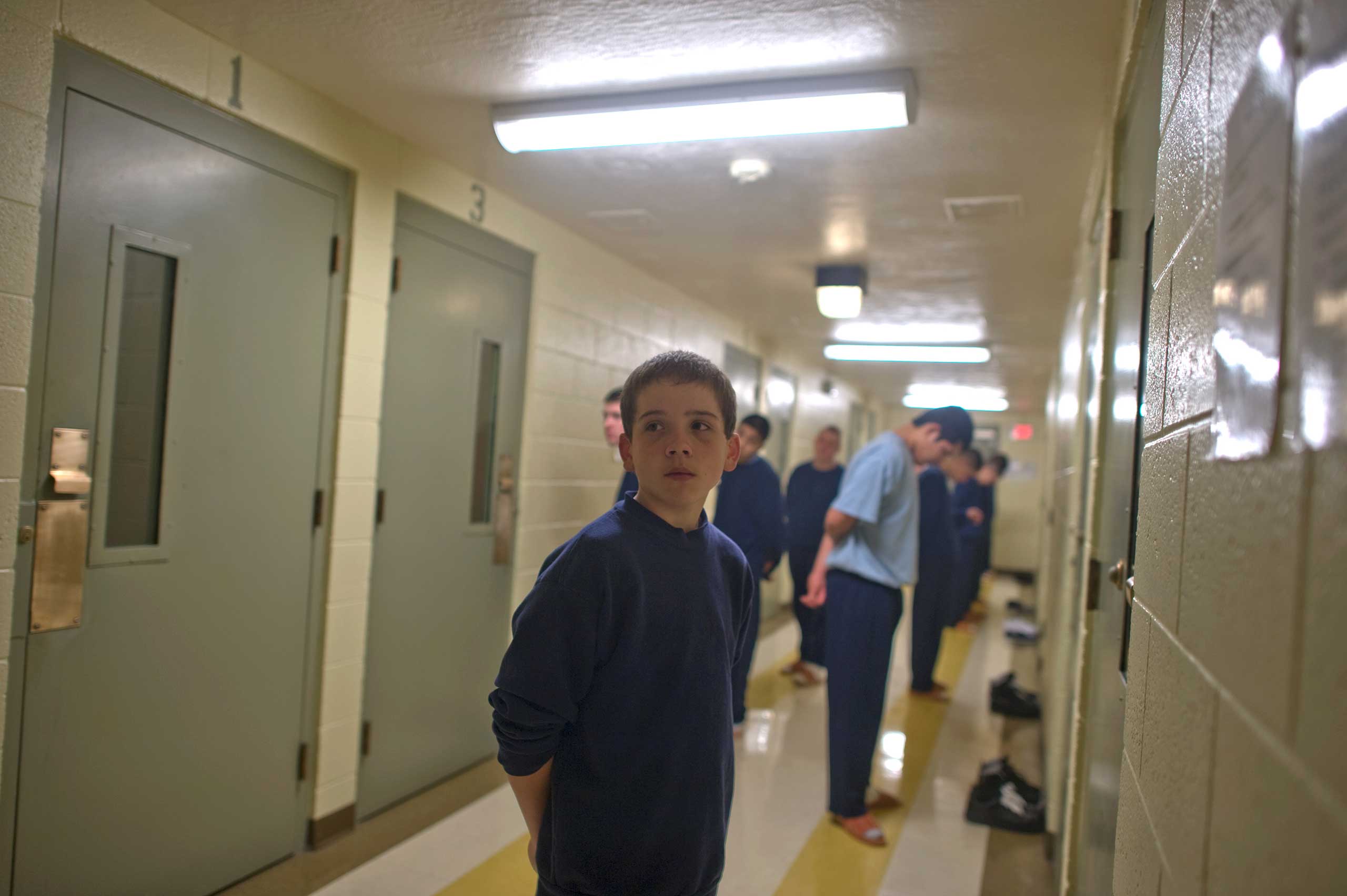 Vinny, 13, stands in command call before entering his cell at the juvenile detention center.