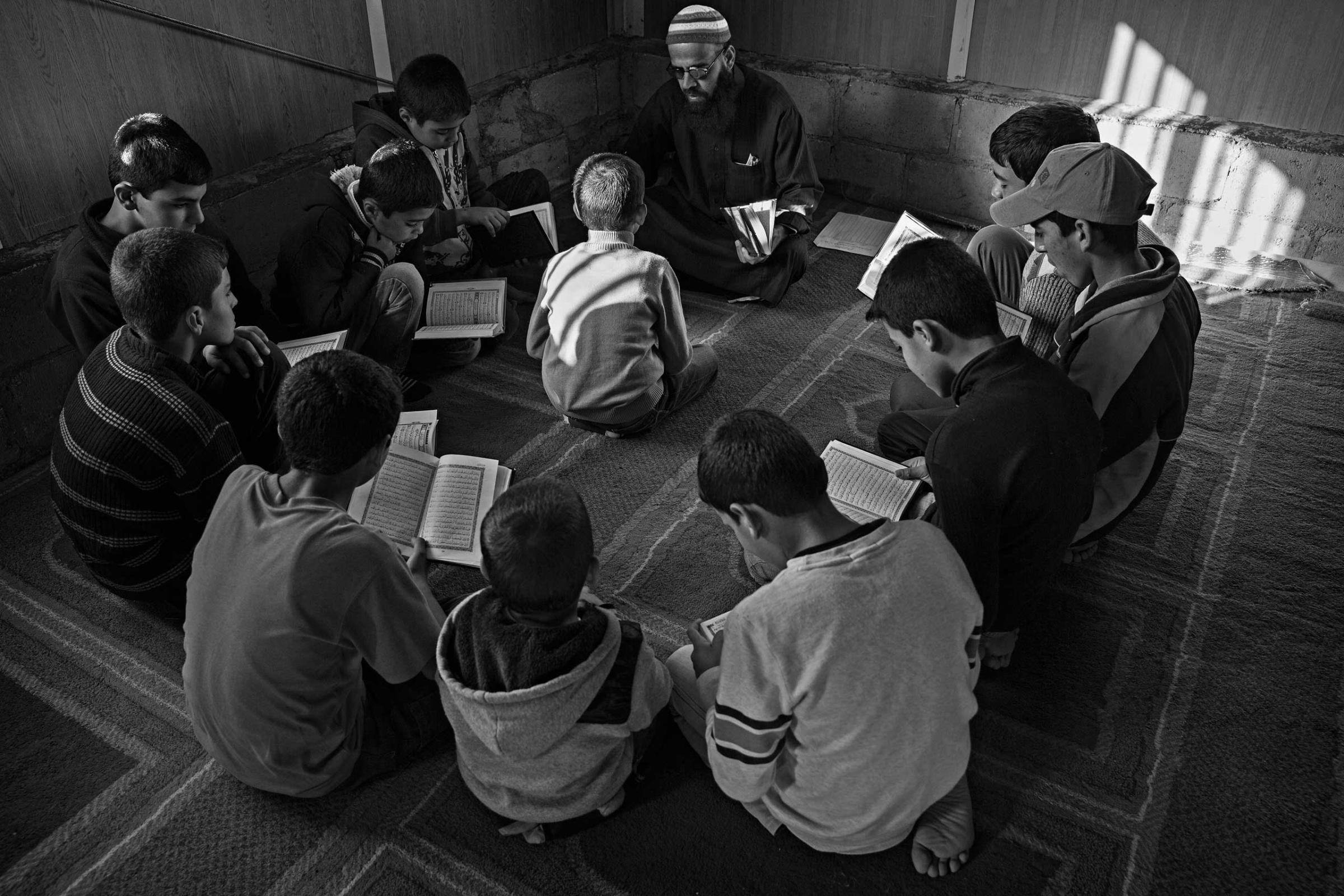 December 2013. Za'atari refugee camp, Jordan. Young boys learning the Koran during daily classes in a mosque.