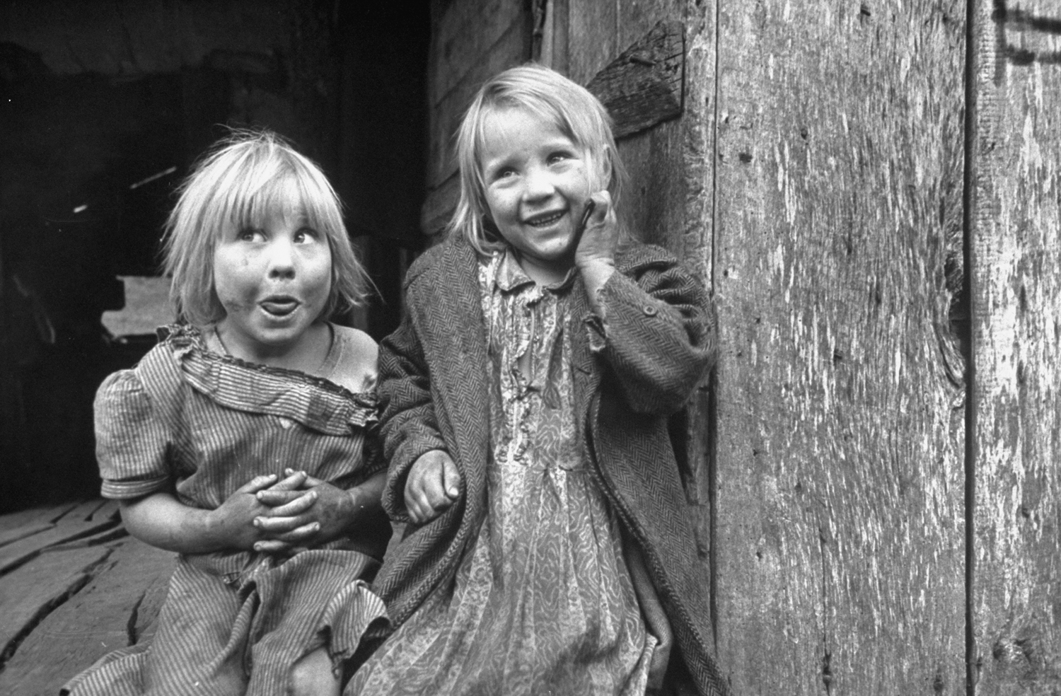 Happy children are Flora (left), 4, and Jackline Couch, 6. They belong to seven-child family at foot of Thousandsticks Mountain.