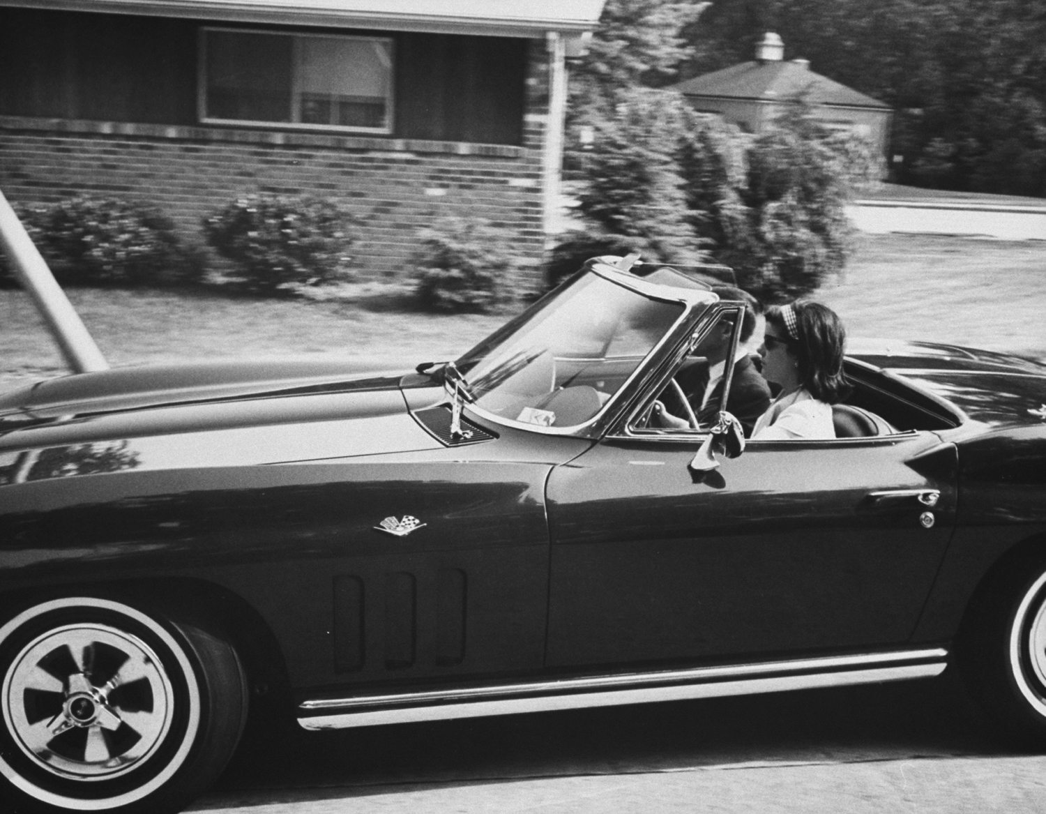 Luci Baines Johnson with Secret Service agent in her Corvette Stingray, 1965.