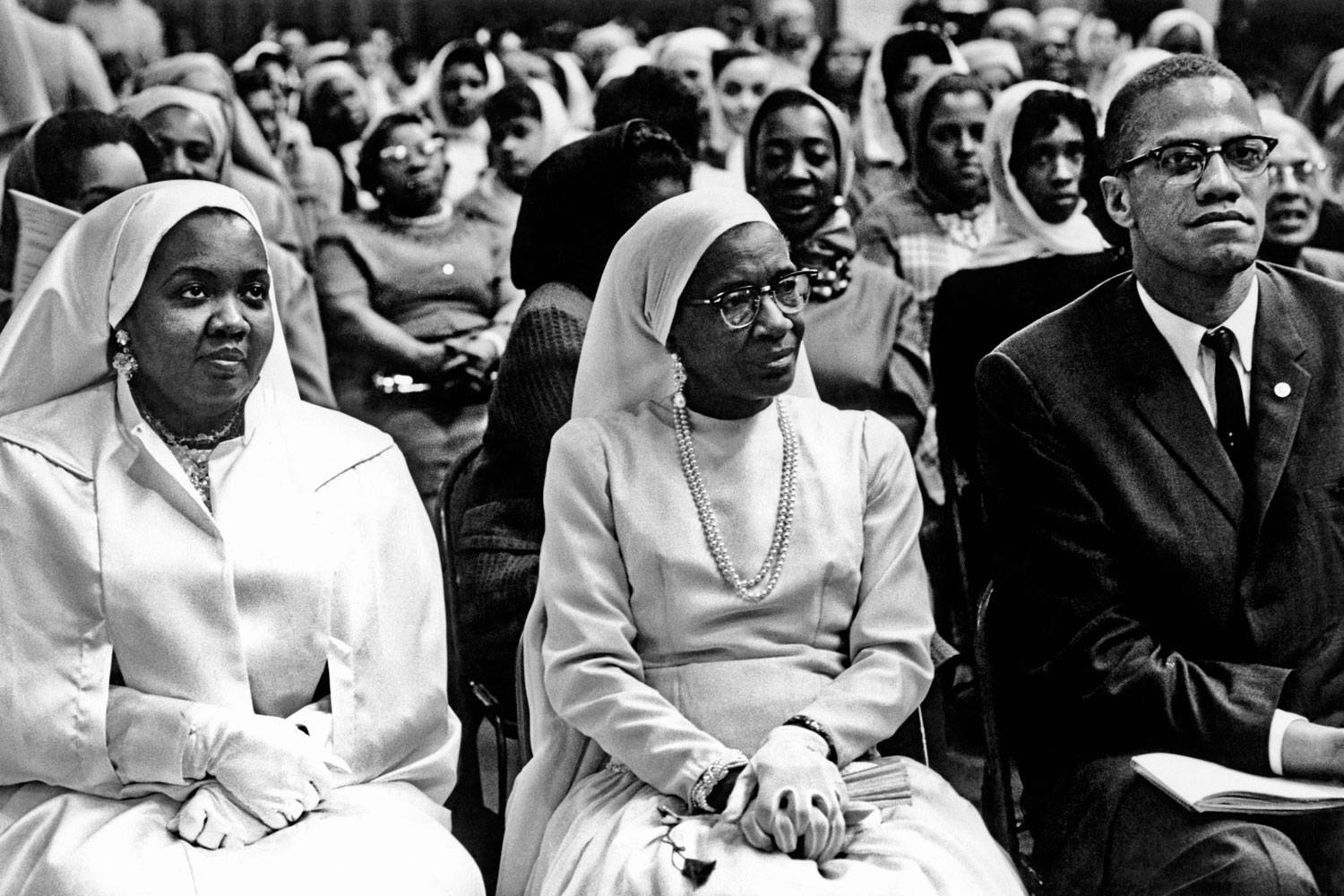 Daughter and wife of Elijah Muhammad with Malcolm X, Chicago, 1961.