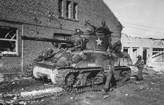 An African-American tank crew prepares a Sherman M4 for battle 