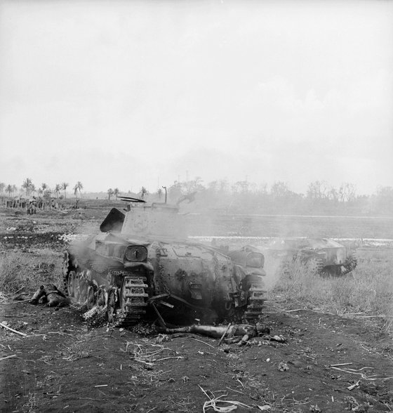 The body of a Japanese soldier lies in front of a smoldering Japanese tank -- mute testament to the savage nature of the fight for control of Saipan in 1944.