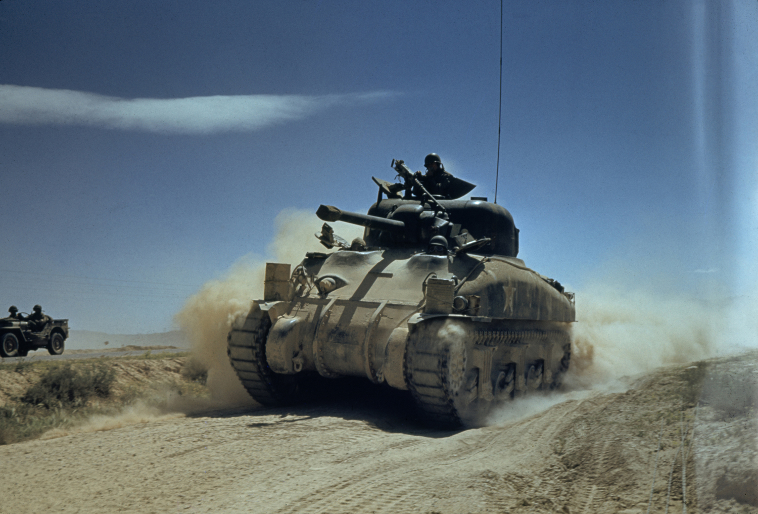 An American tank races along during desert fighting between U.S. and German forces in the El Guettar Valley, North Africa, 1943.