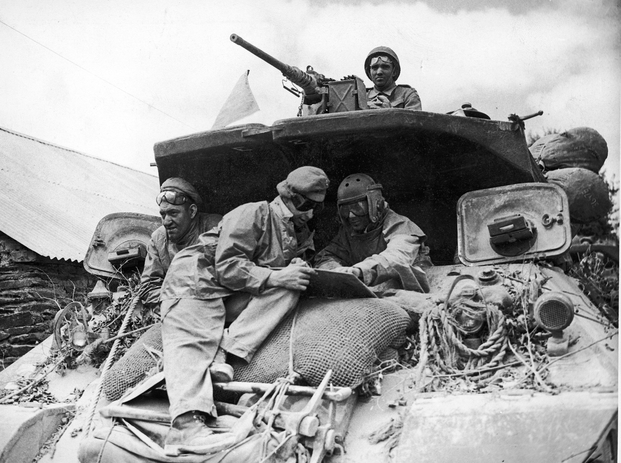 American tank crew checks its map in Normandy, 1944.