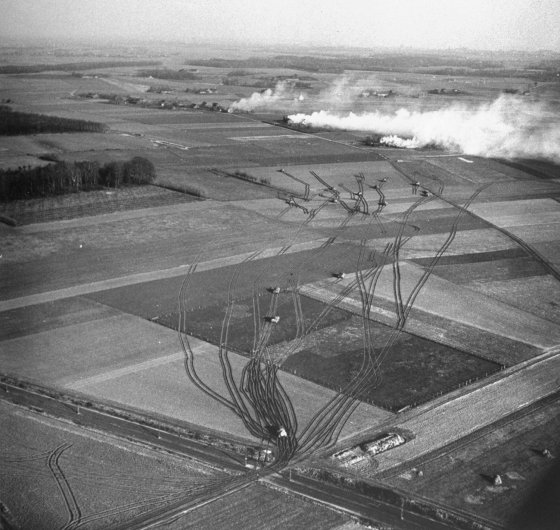 Aerial view of U.S. 2nd Armored Division tanks fanning out as German self-propelled guns open fire, two miles from the Rhine River, 1945.